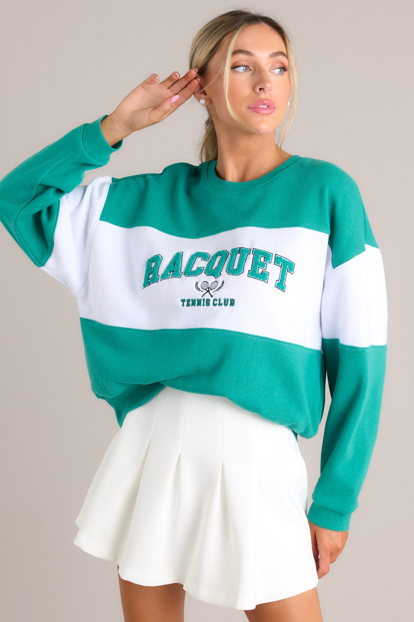 Full front view of this sweatshirt that features a ribbed crew neckline, high contrast color blocking, embroidered & terry cloth wording, ribbed cuffed sleeves, and a ribbed hemline.