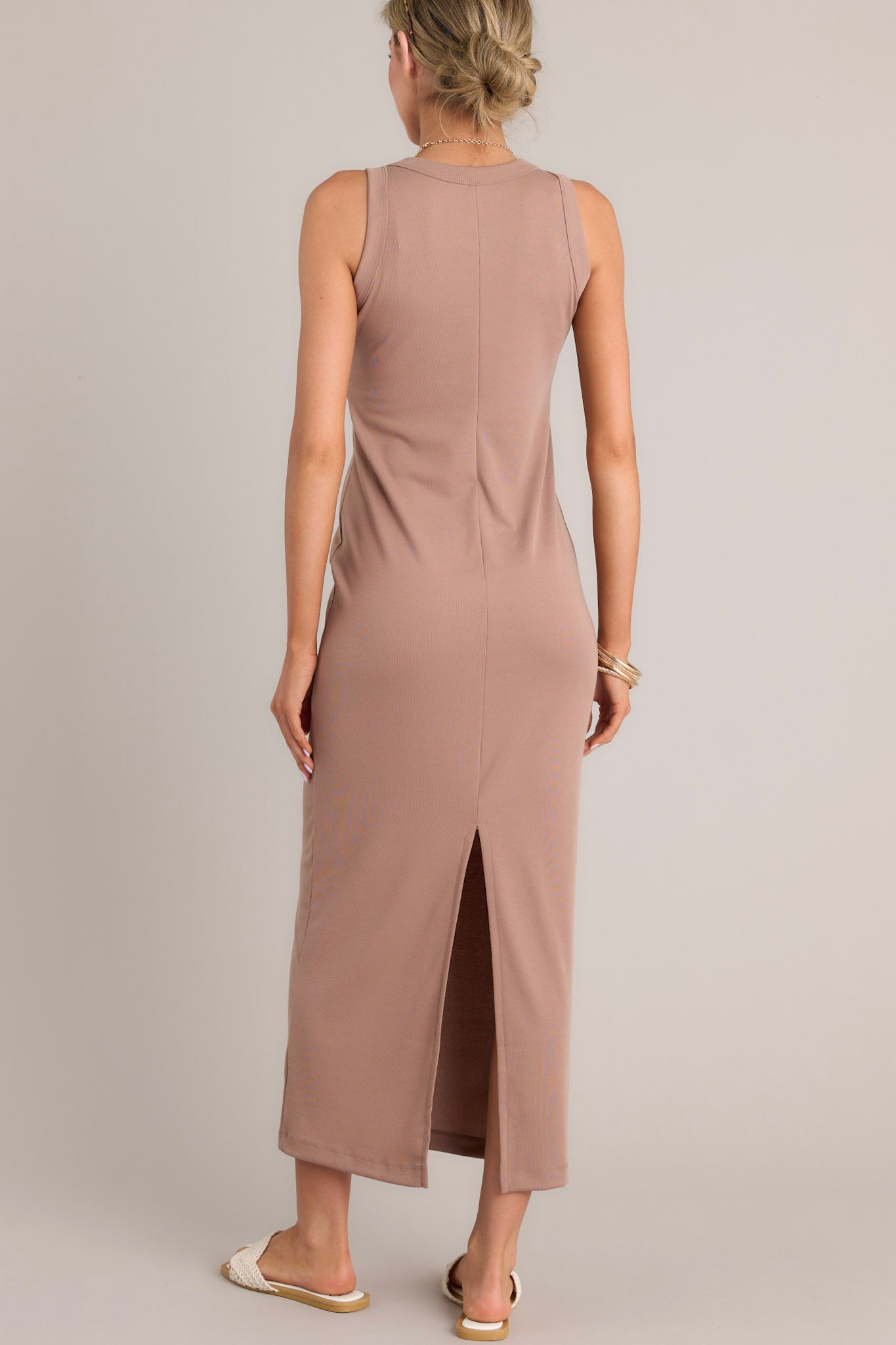 Back view of this dress that features a scoop neckline, a slit in the back and, a super soft material.