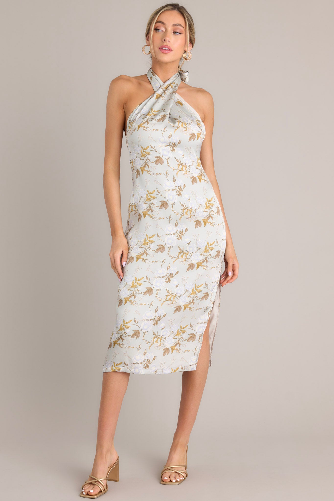 Full body view of this light sage midi dress that features a self-tie halter neckline, an open back, a discrete back zipper, a soft material, and a side slit