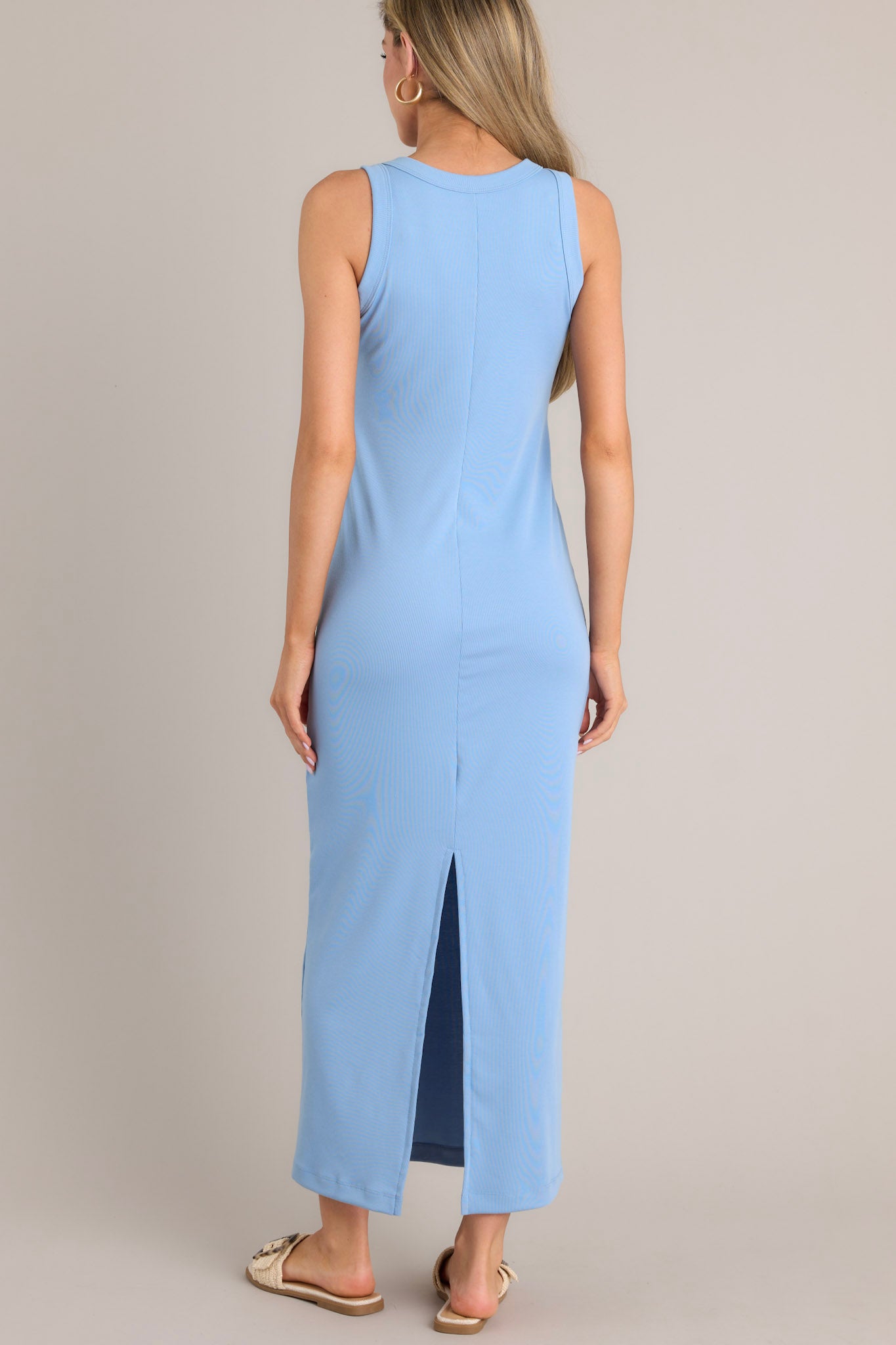 Back view of this dress that features a scoop neckline, a slit in the back and, a super soft material.
