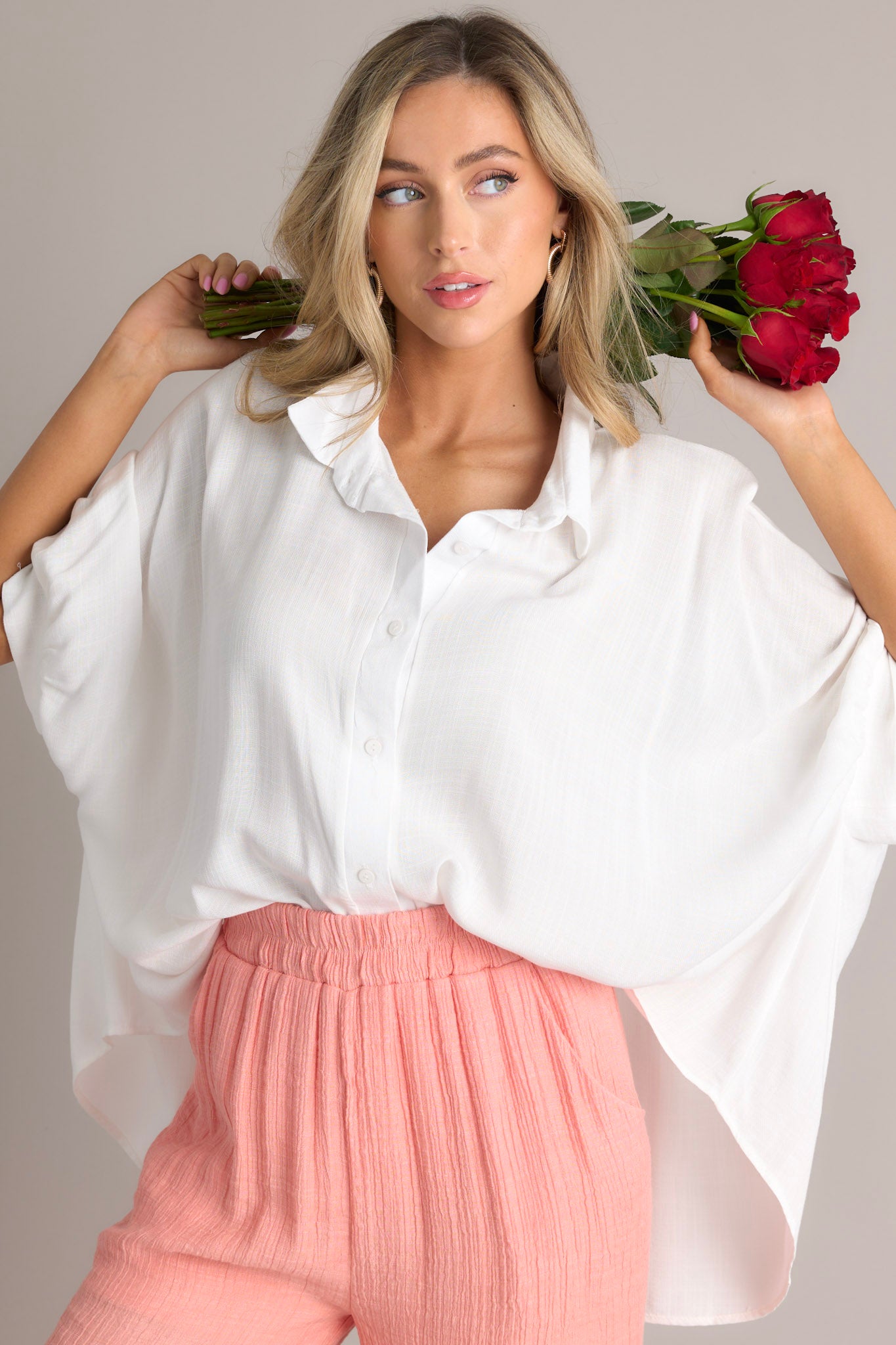 Front view of this top that features a collar neckline and functional buttons down the middle.