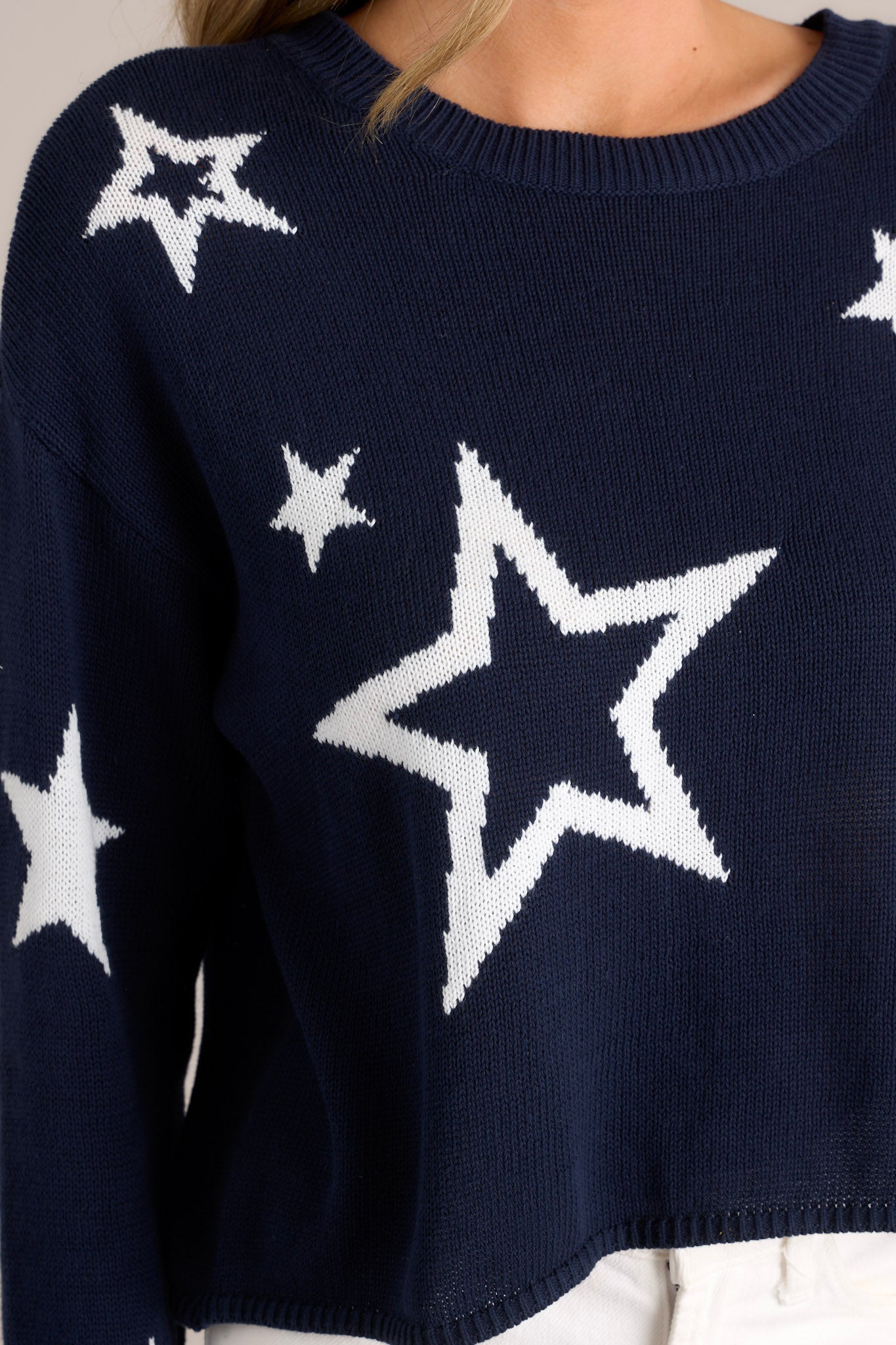 Close up view of material of this top that features a crew neckline, a slightly cropped style, a fun star print, and a relaxed fit.