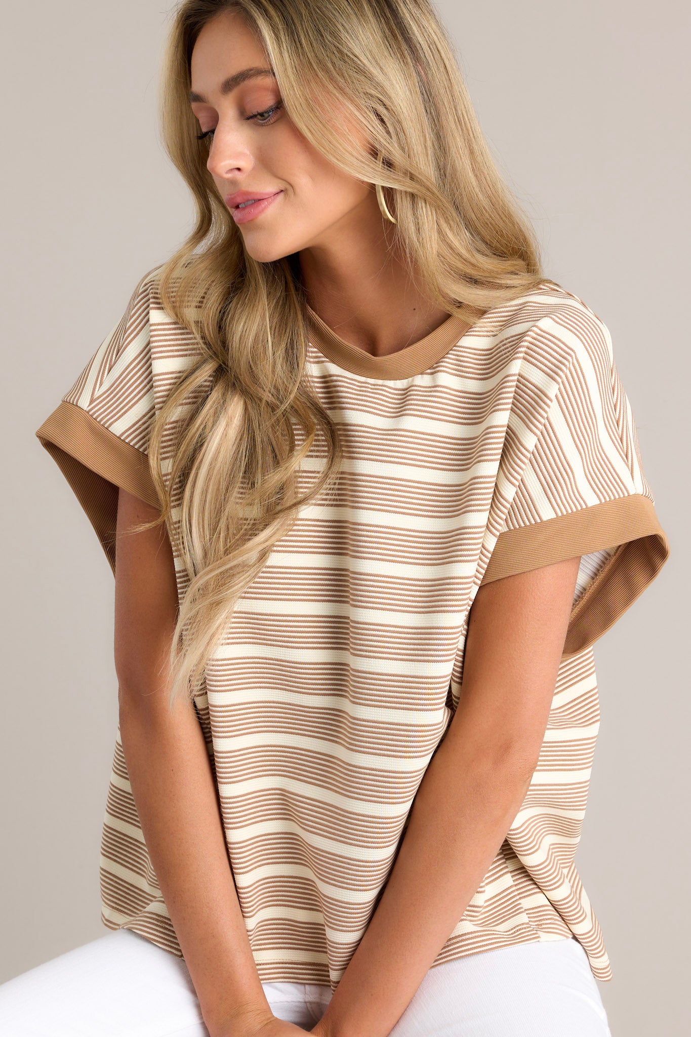 This camel stripe top features a crew neckline, a unique stripe pattern, and thick sleeve hemlines.