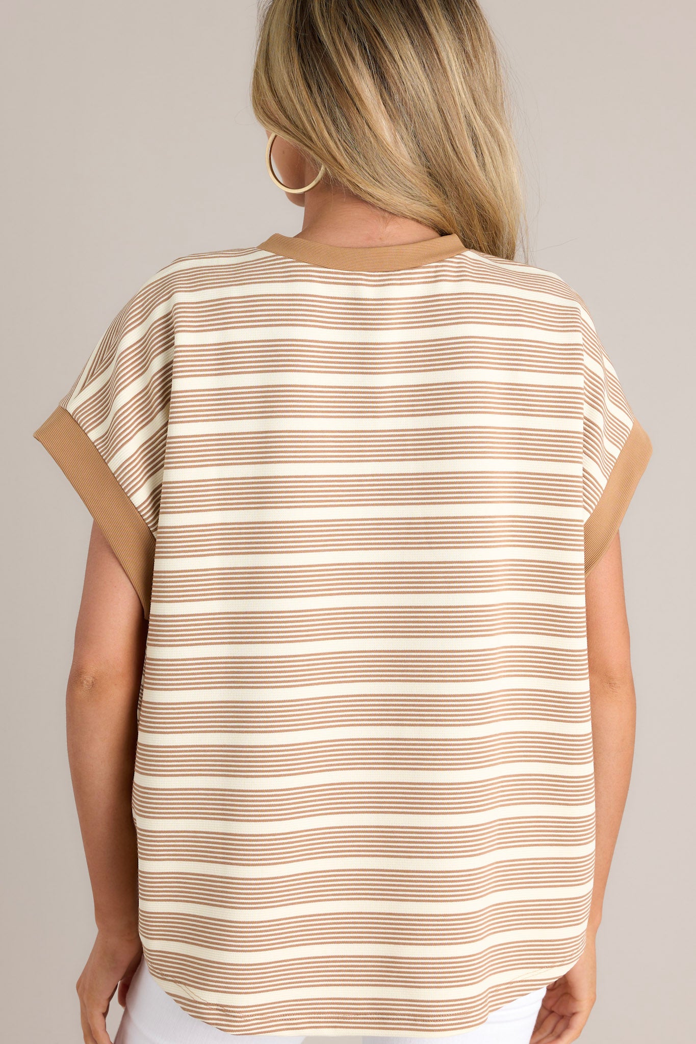 Back view of this camel stripe top that features a crew neckline, a unique stripe pattern, and thick sleeve hemlines.