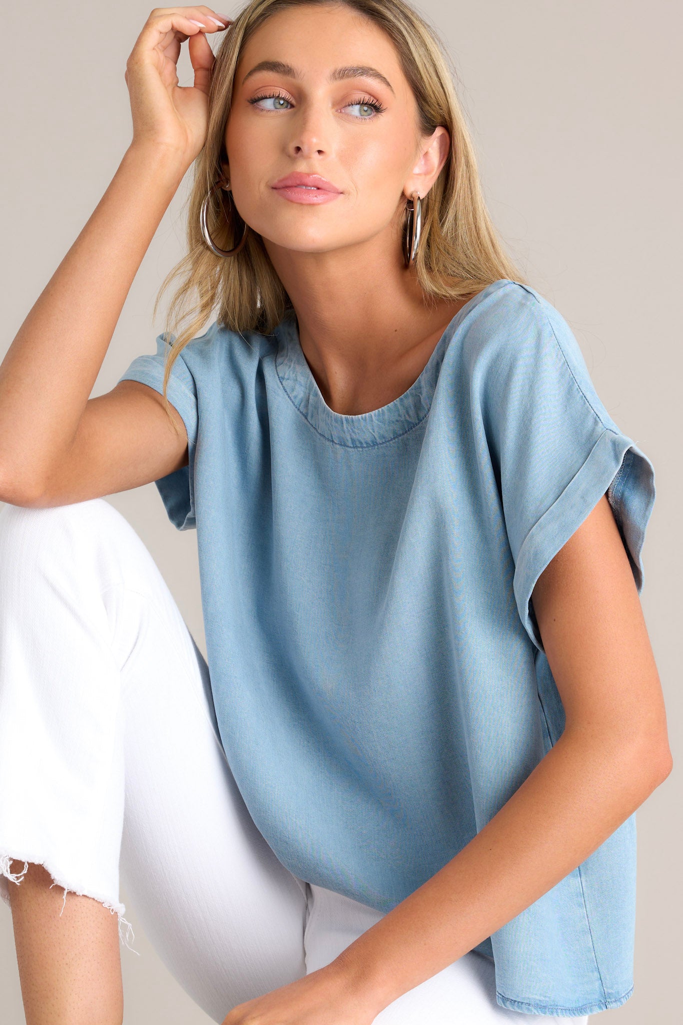 This light chambray top features a crew neckline, a relaxed fit, and a wide cuffed short sleeves.