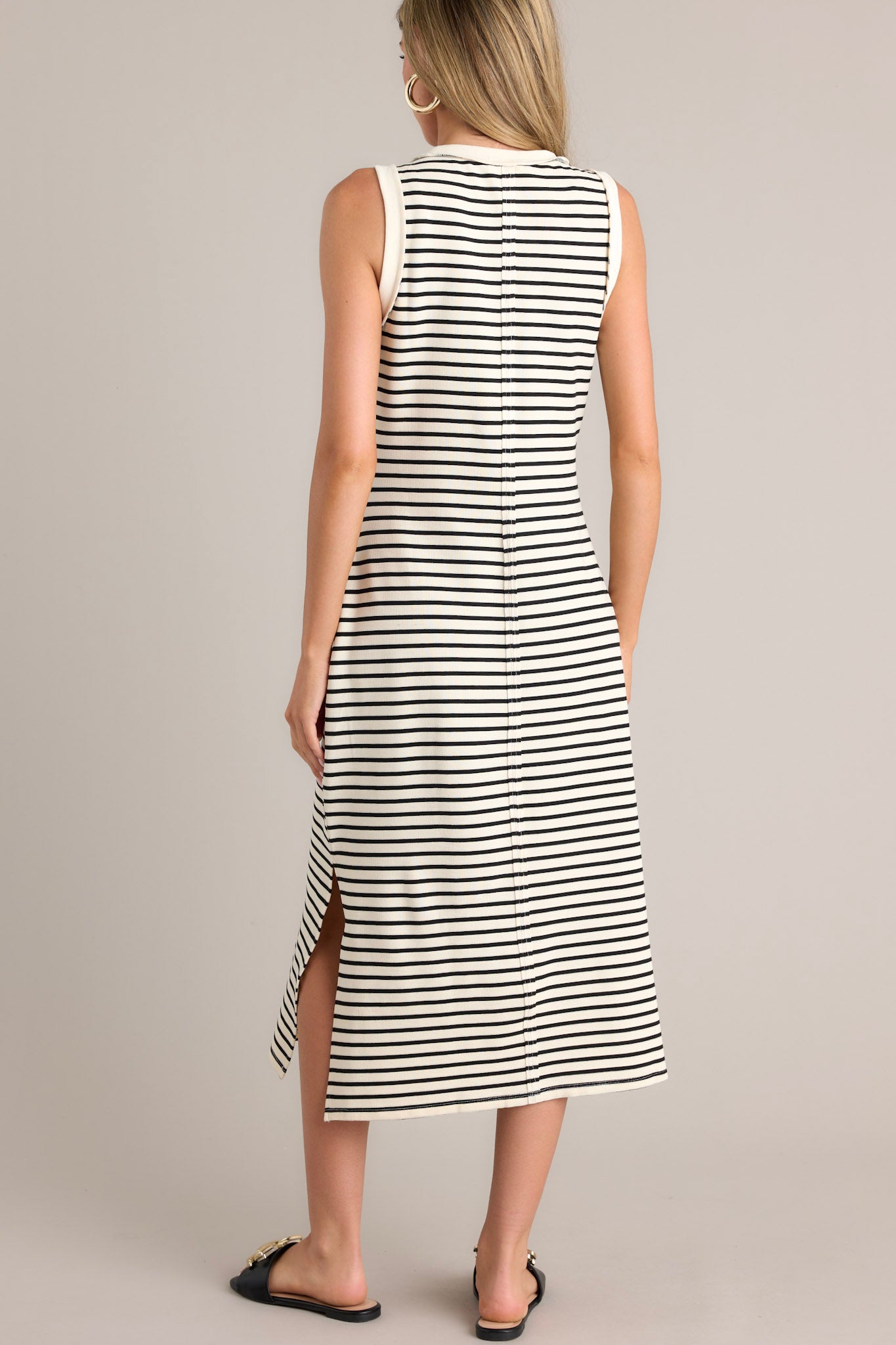 Back view of this stripe midi dress that features a crew neckline, a classic horizontal stripe design, and a split hemline.