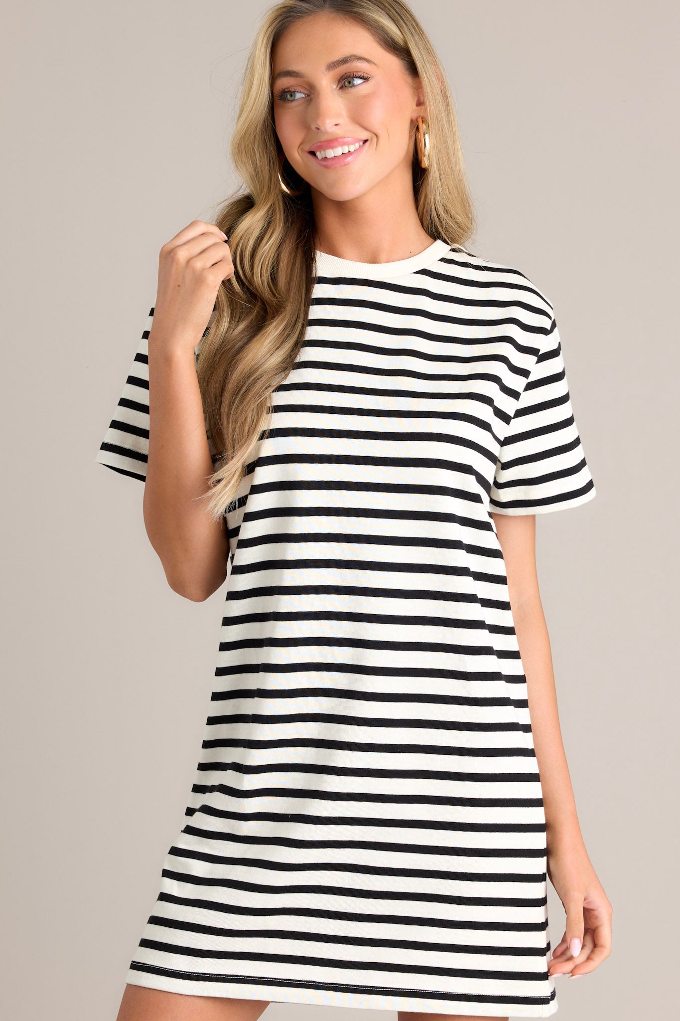 Front view of this white stripe mini dress that features a crew neckline, wide short sleeves, and a classic stripe pattern.