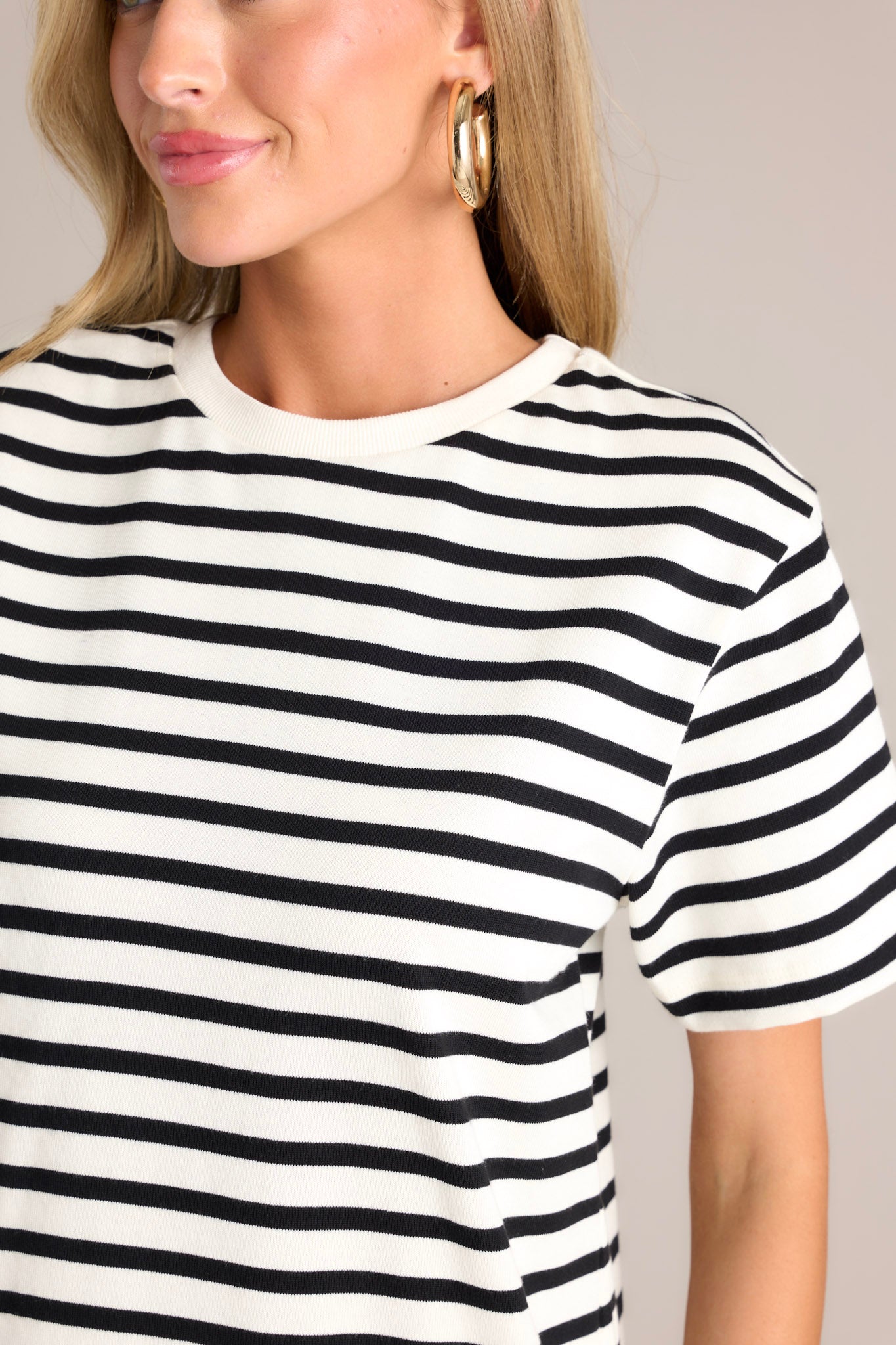 Close up view of this white stripe mini dress that features a crew neckline, wide short sleeves, and a classic stripe pattern.