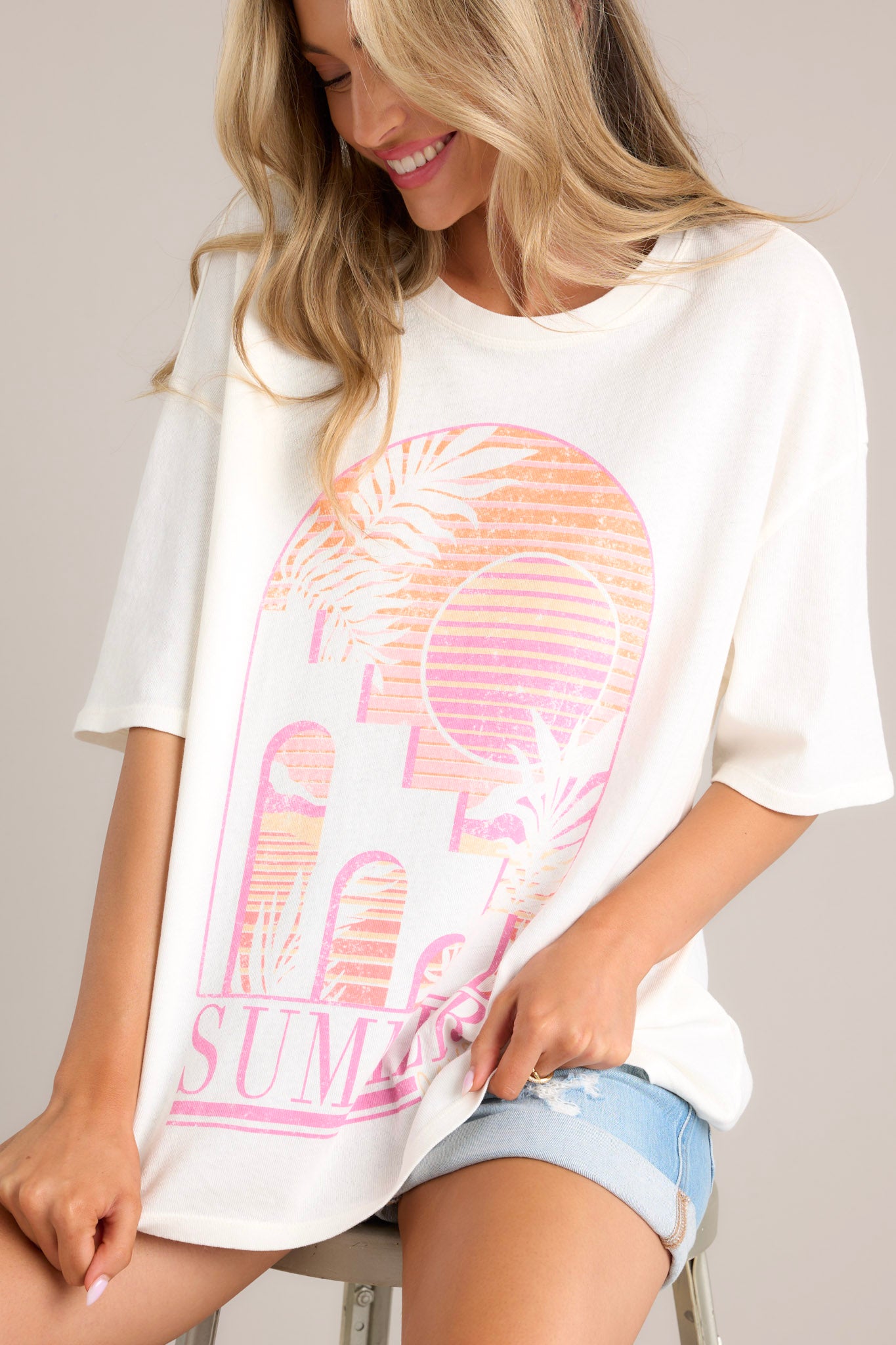 This tee boasts a classic crew neckline, adorned with a summer-themed graphic, and designed with an oversized fit for ultimate comfort. It features wide half sleeves for a relaxed and breezy look.