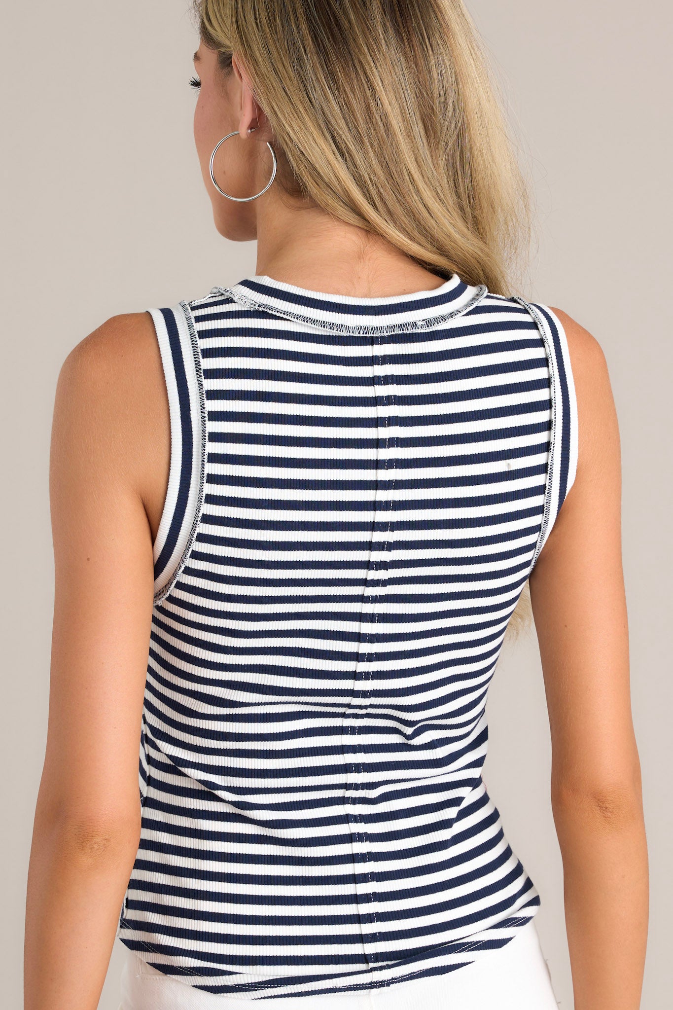 Back view of this tank that features a ribbed scoop neckline, a classic stripe pattern, a ribbed texture, and a scoop hemline.