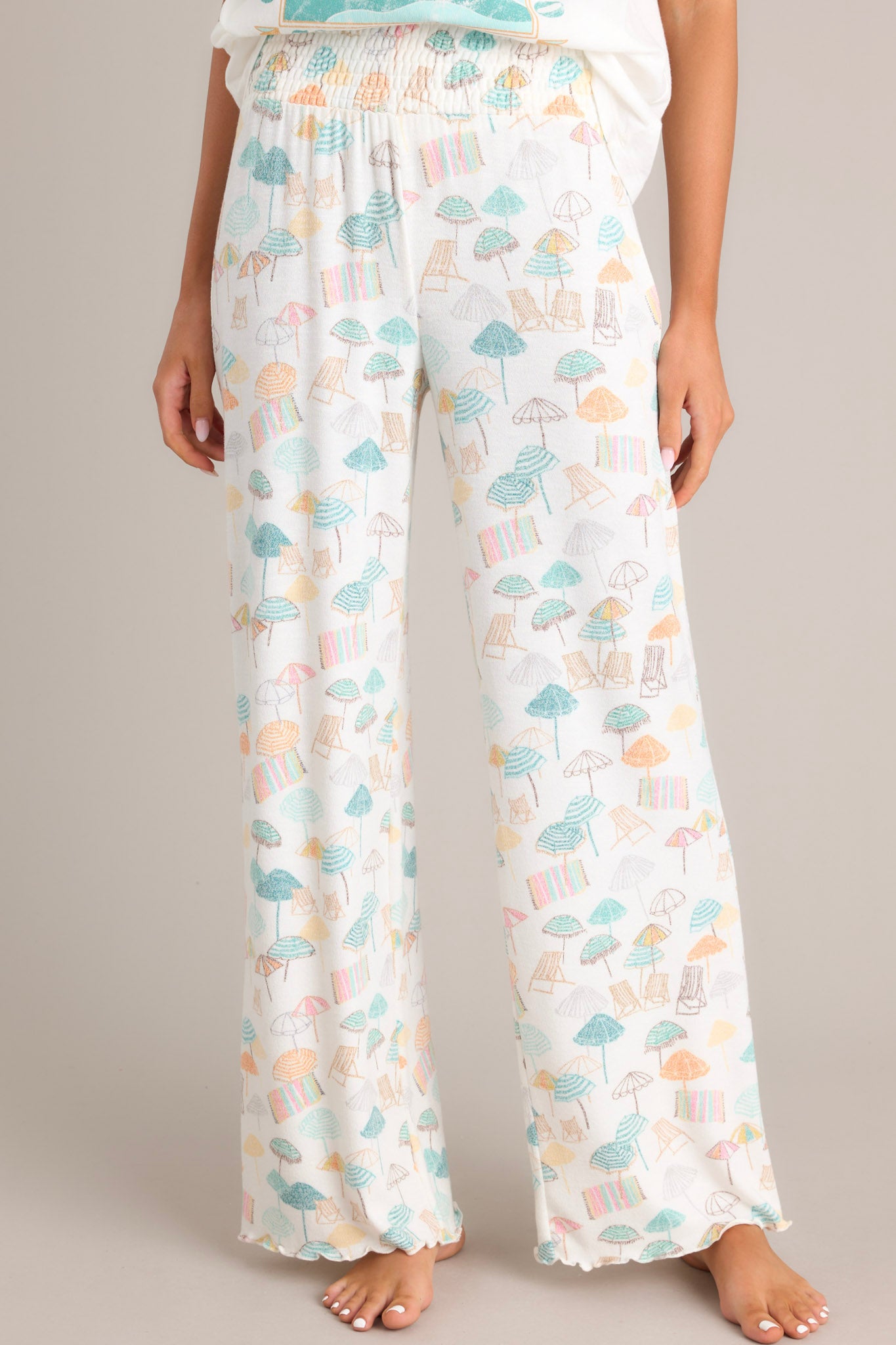 These pants feature a high waisted design, a fully smocked waistband, a super soft material, a wide leg, and a scalloped hemline.