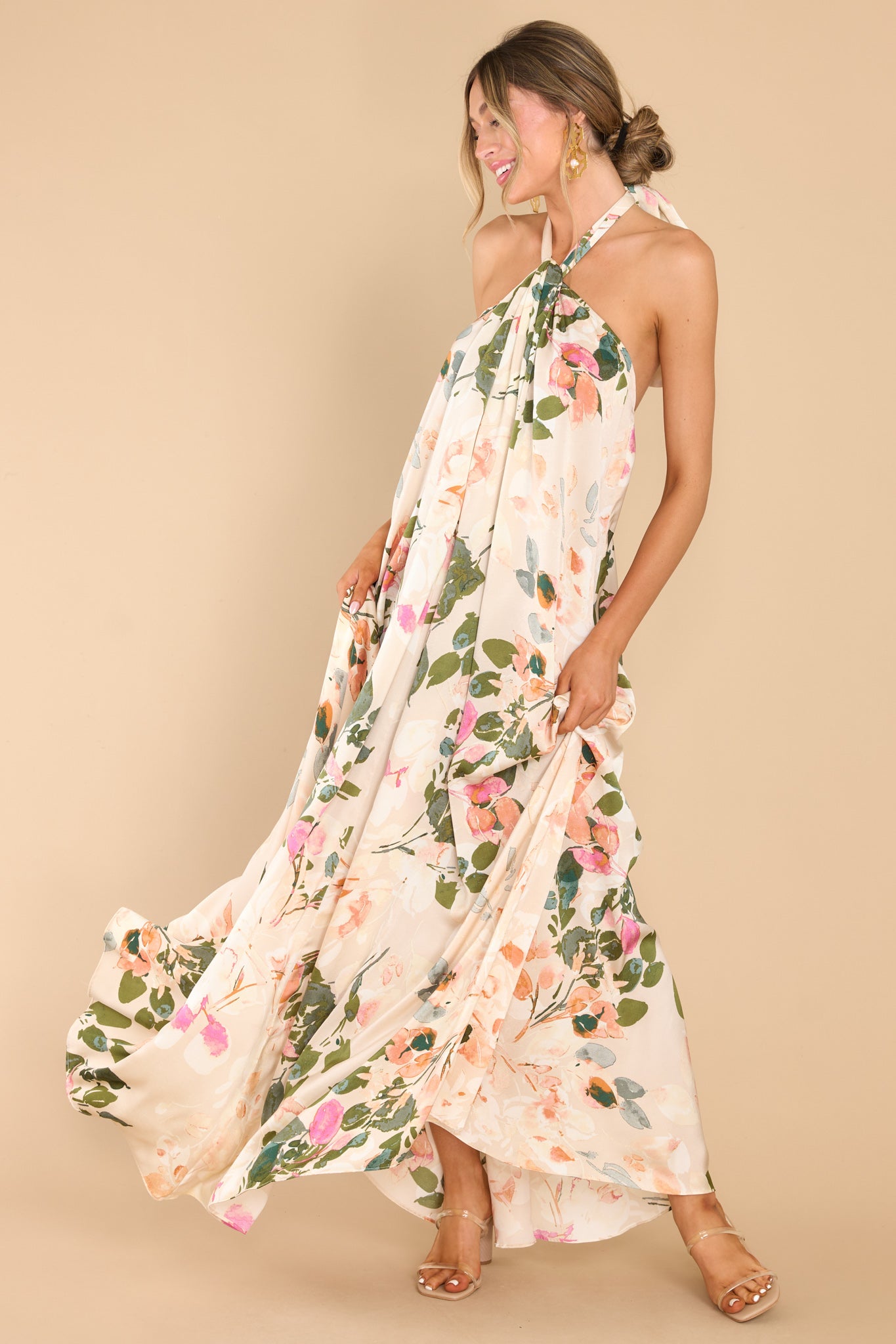 Full body view of this dress that features the green, pink, and orange floral pattern of the tan fabric.