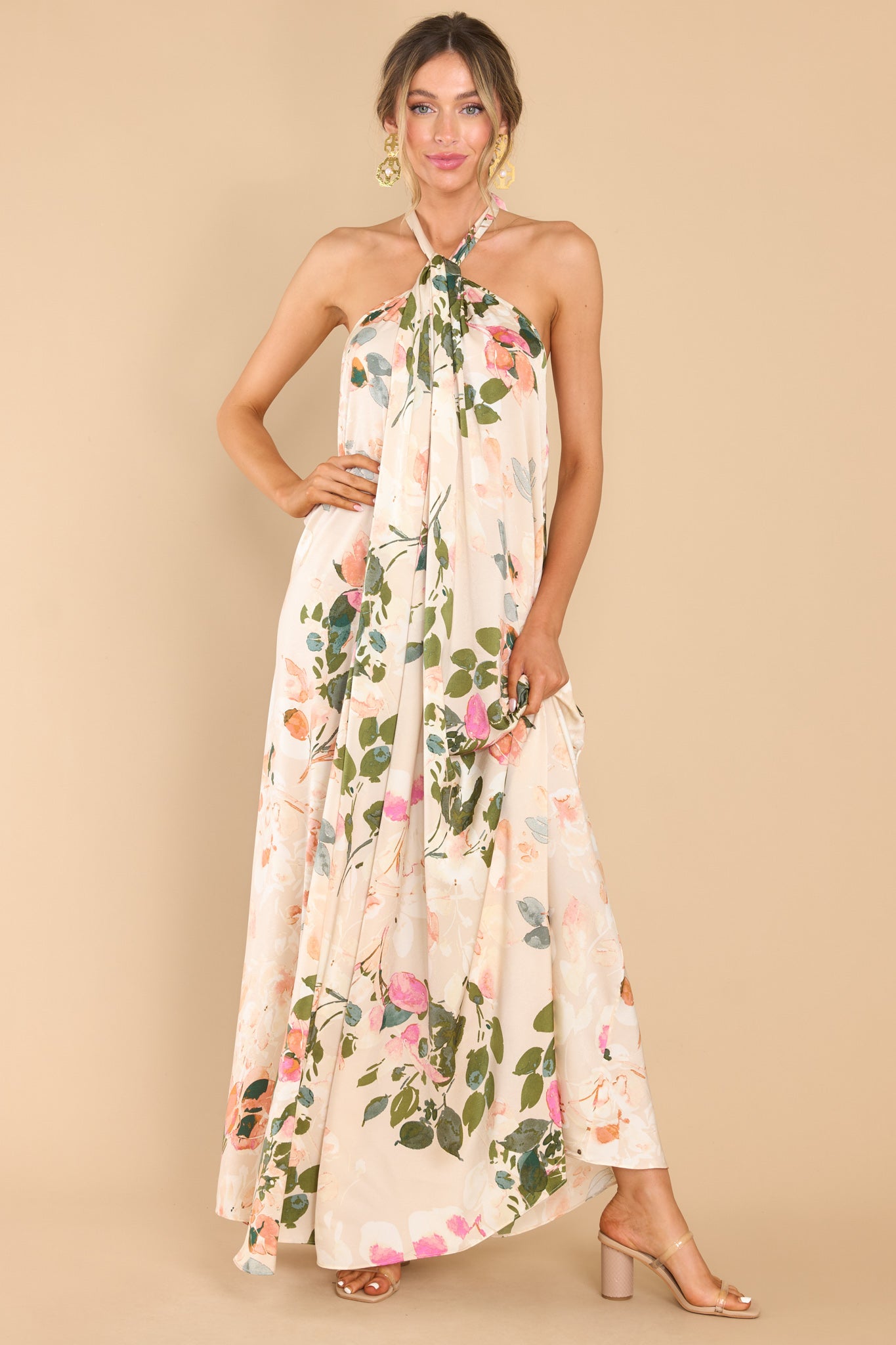 Front view of  this dress that features a high neckline with keyhole cutouts and halter self tie around the neck, open back, elastic along lower back seam, and a flowy fit throughout.