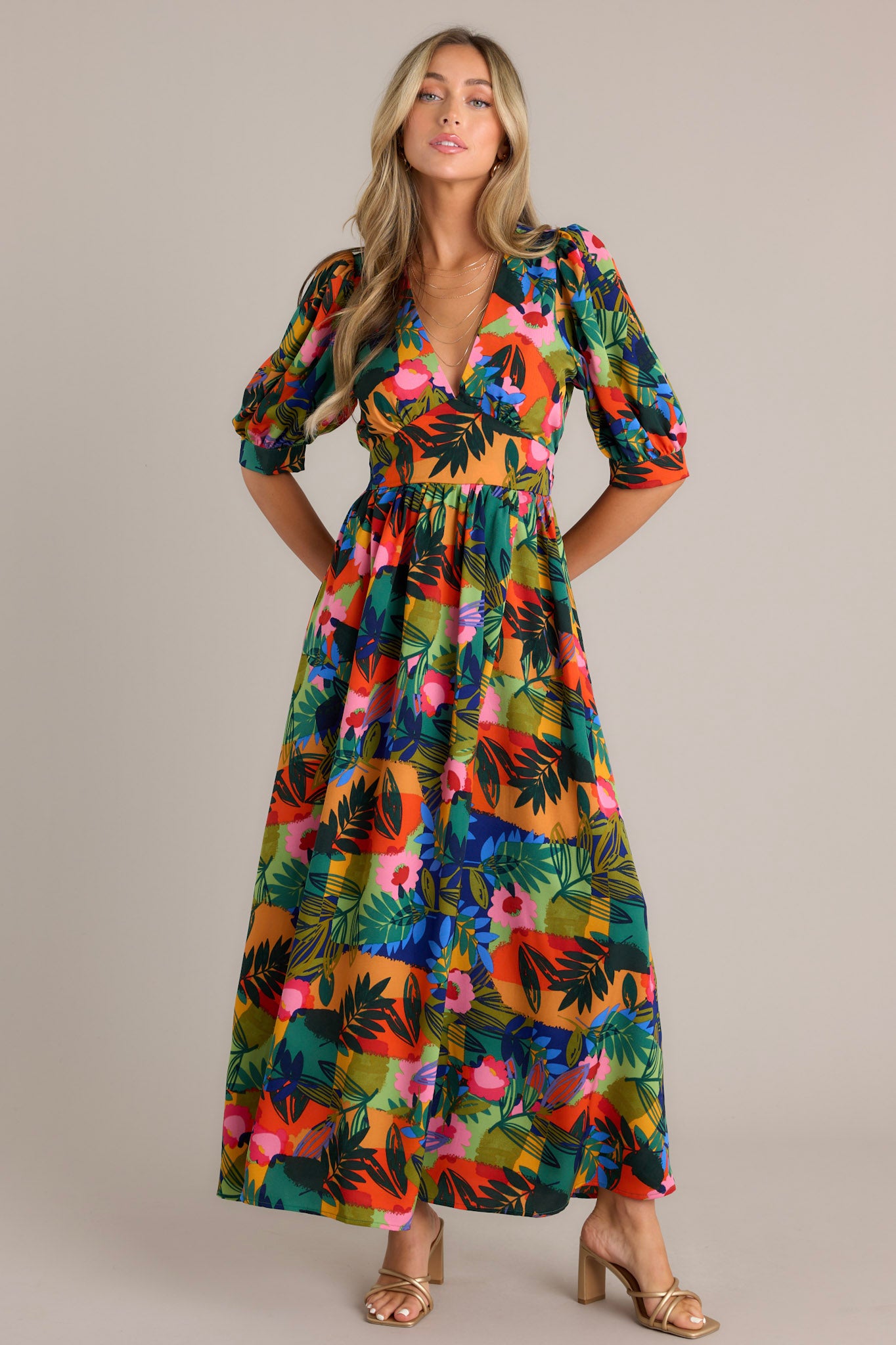 Front view of a tropical print maxi dress with puff sleeves and a V-neckline.