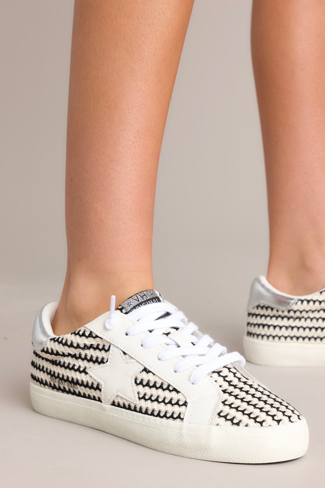 These black and white shoes feature a rounded toe, no-tie laces, replacement laces, star detailing , and a thick sole.