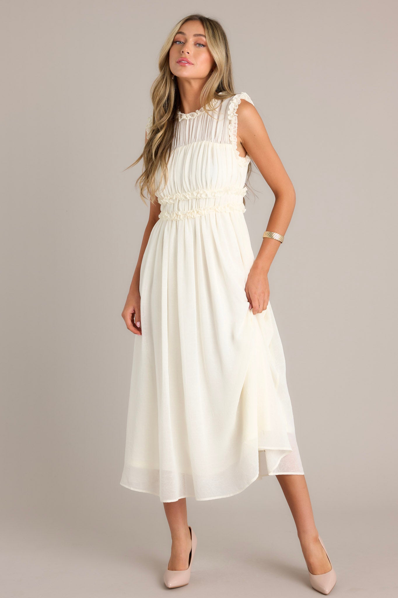 Ivory dress showcasing a high neckline with ruffle detailing, a back zipper closure, and a keyhole opening at the back.