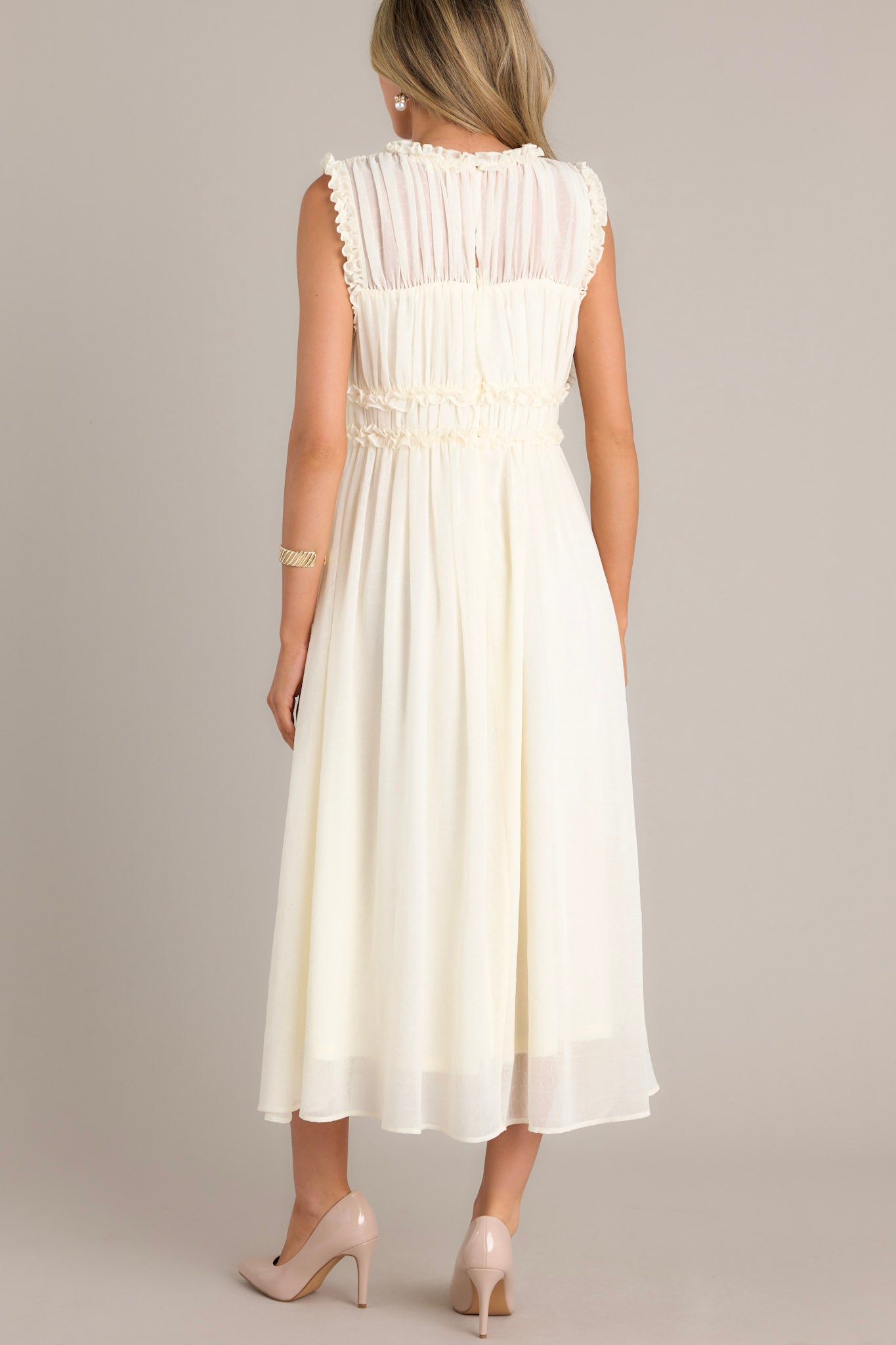 Back view of the ivory dress featuring a high neckline, keyhole opening, and back zipper.