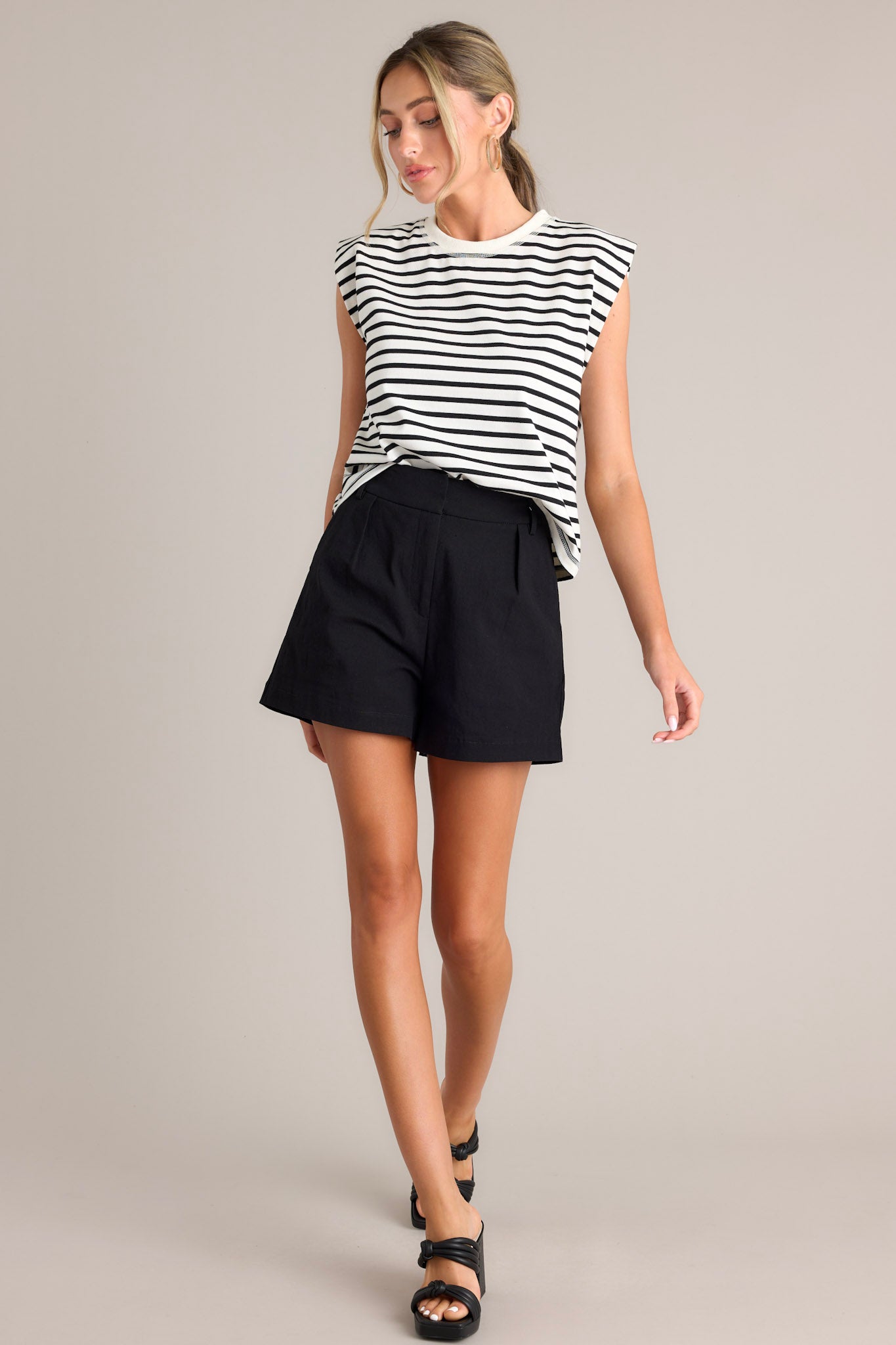 Front view of this white stripe top that features a crew neckline, short cap sleeves, and a classic stripe pattern.