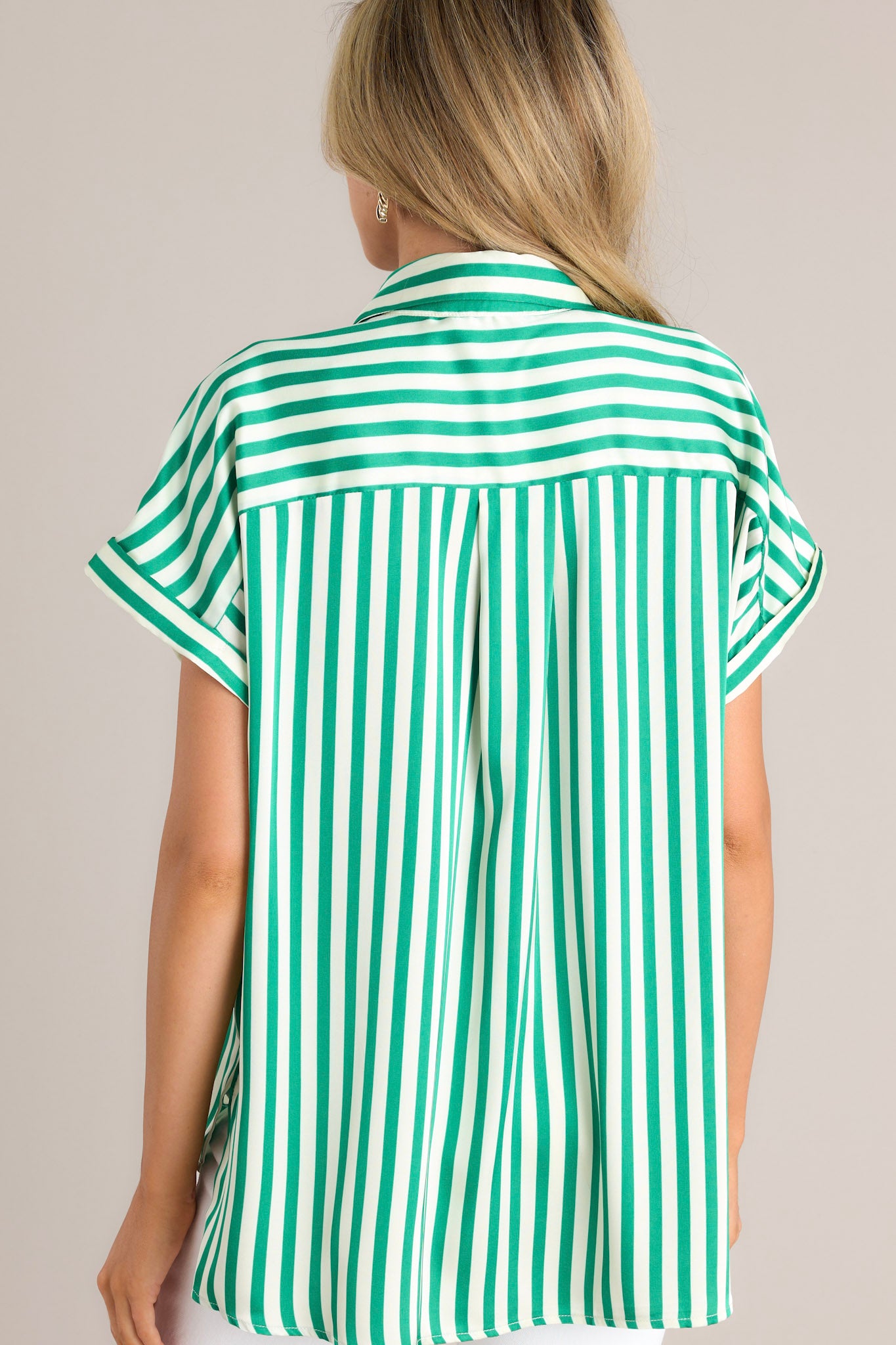 Back view of a green and white striped button-up shirt showcasing the short sleeves and collared neckline.