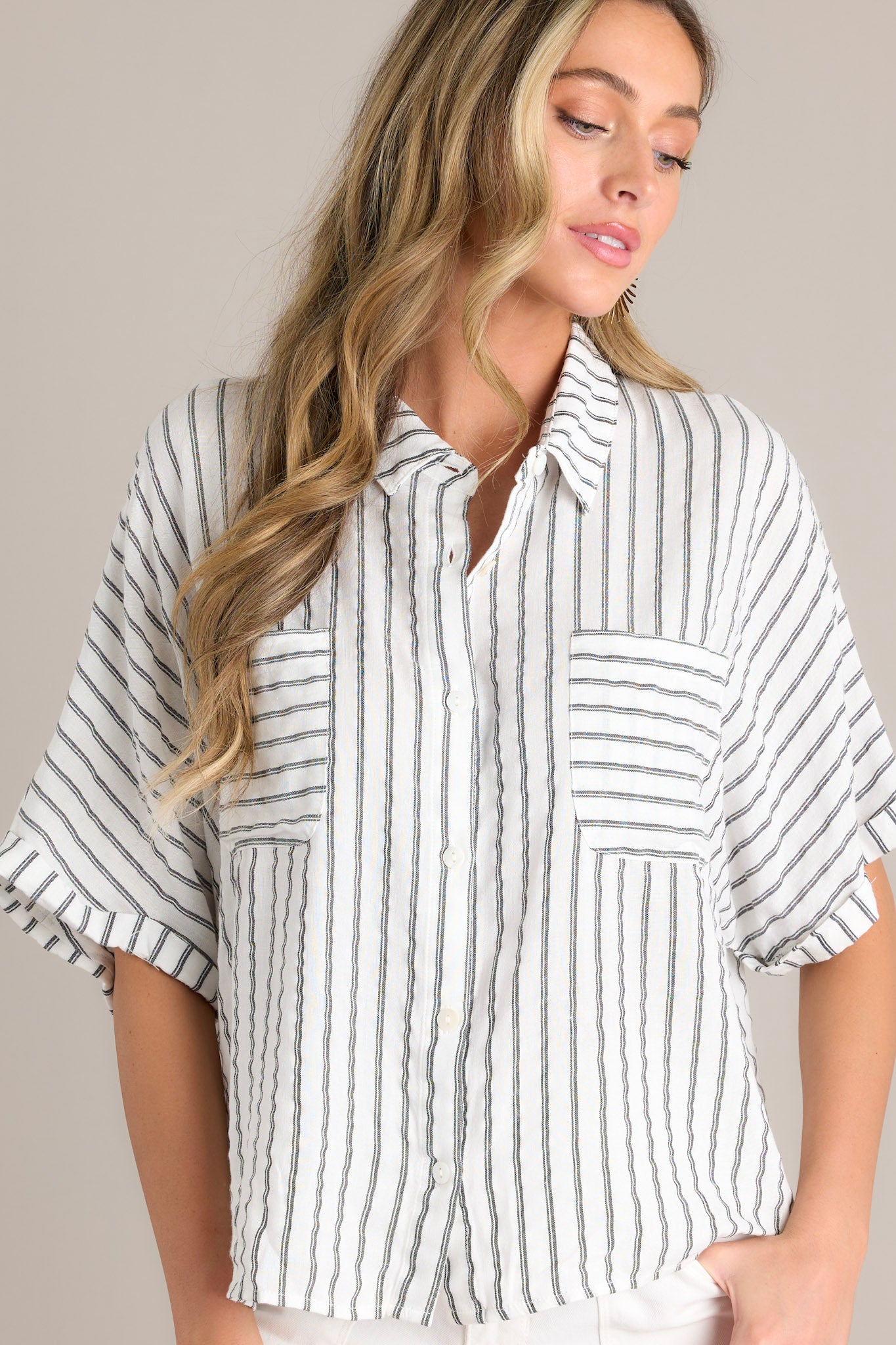 Front Close-up of the black stripe top showing the collared neckline, functional button front, functional breast pockets, and the combination of vertical & horizontal stripes.