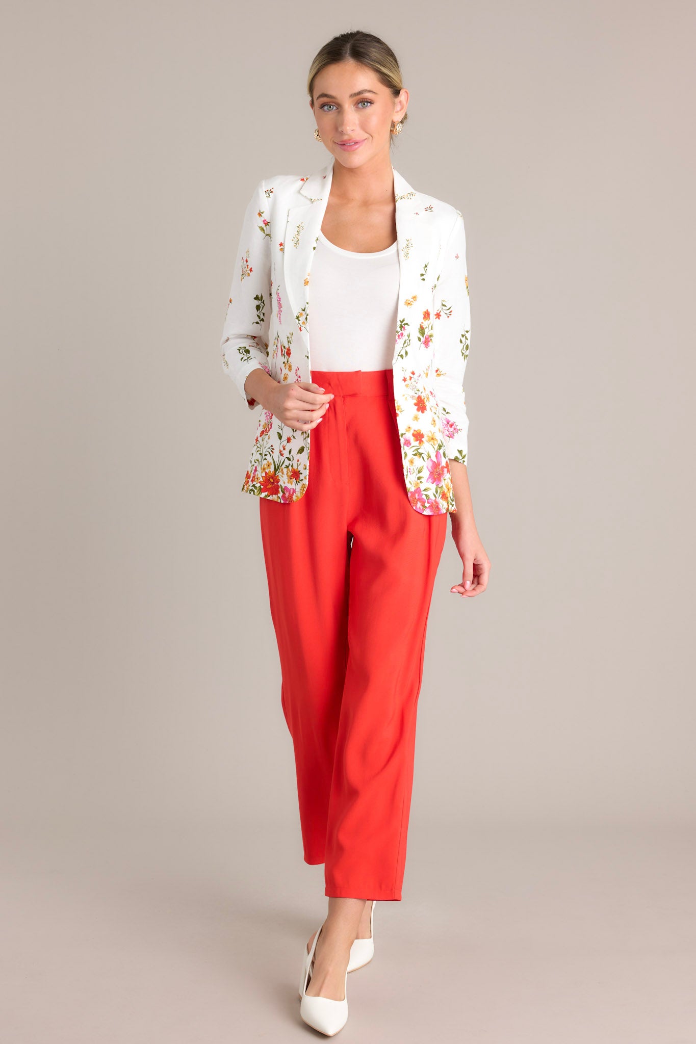 Front view of a blazer featuring a lapel collar, faux front pockets, 3/4 sleeves with a ruched detail, and a floral pattern throughout.