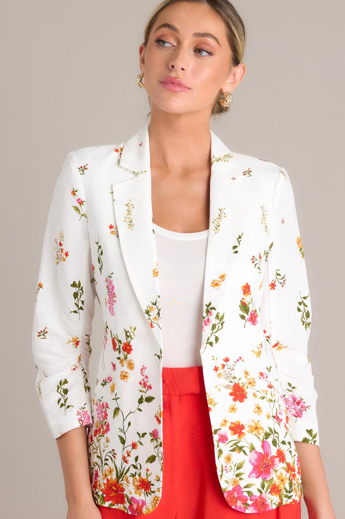 Close-up of the blazer showing the lapel collar, faux front pockets, and the floral pattern.