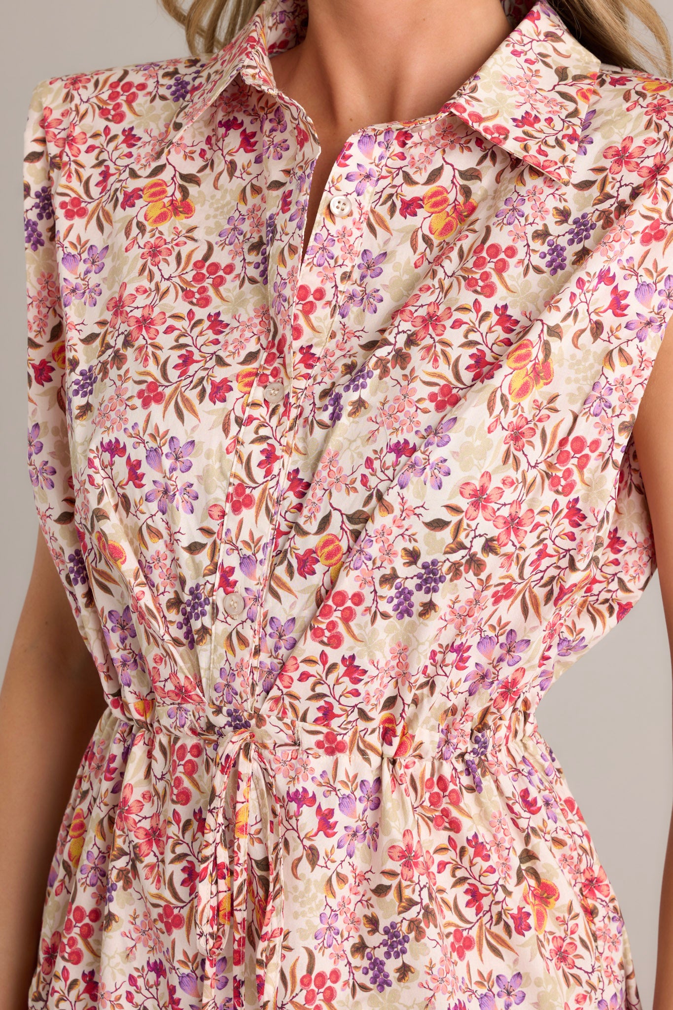 Close-up of the beige floral multi mini dress fabric highlighting the delicate floral print and the textured material.