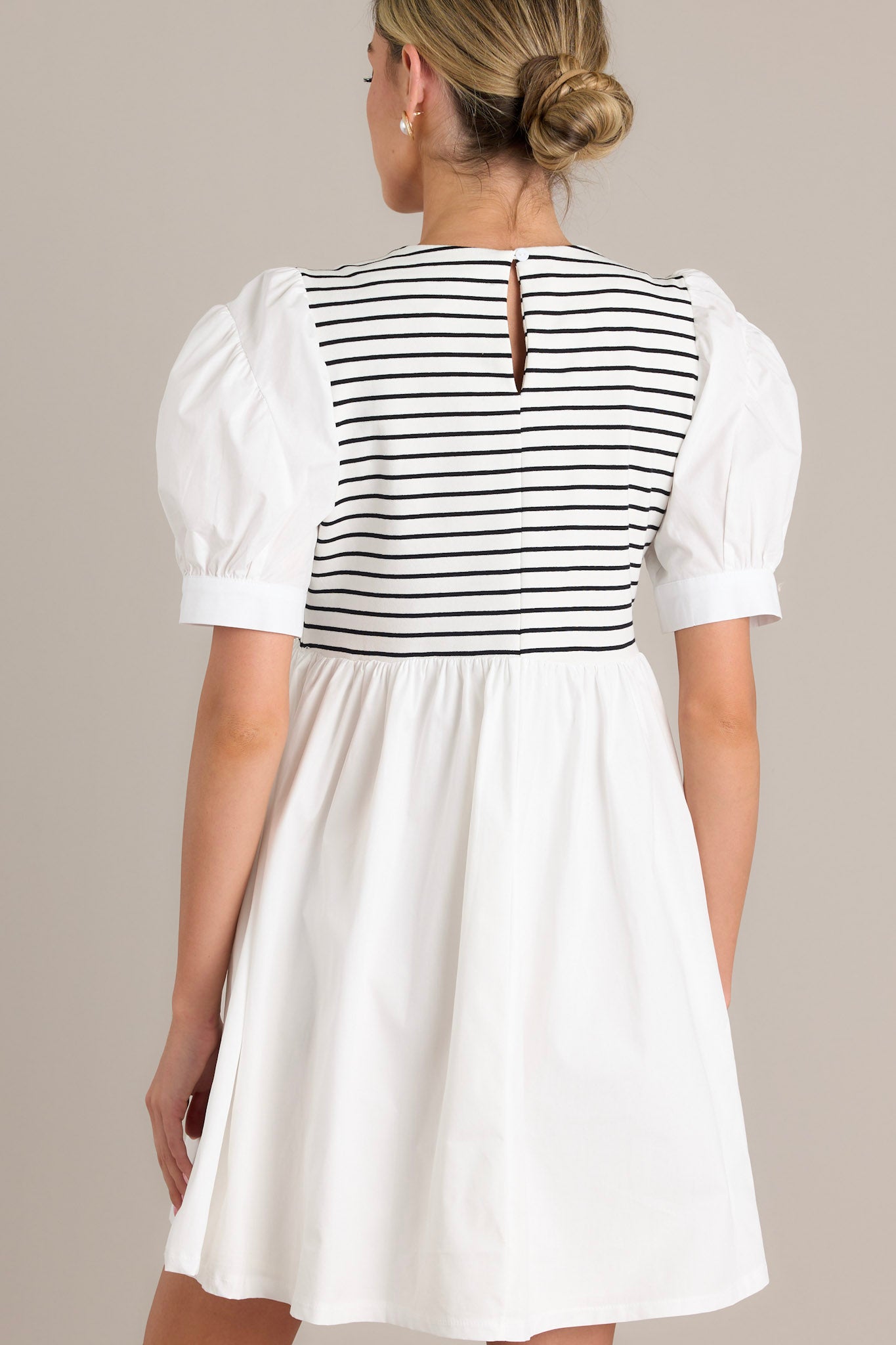 Back view of this dress showcasing trendy horizontal stripes and a keyhole back detail.