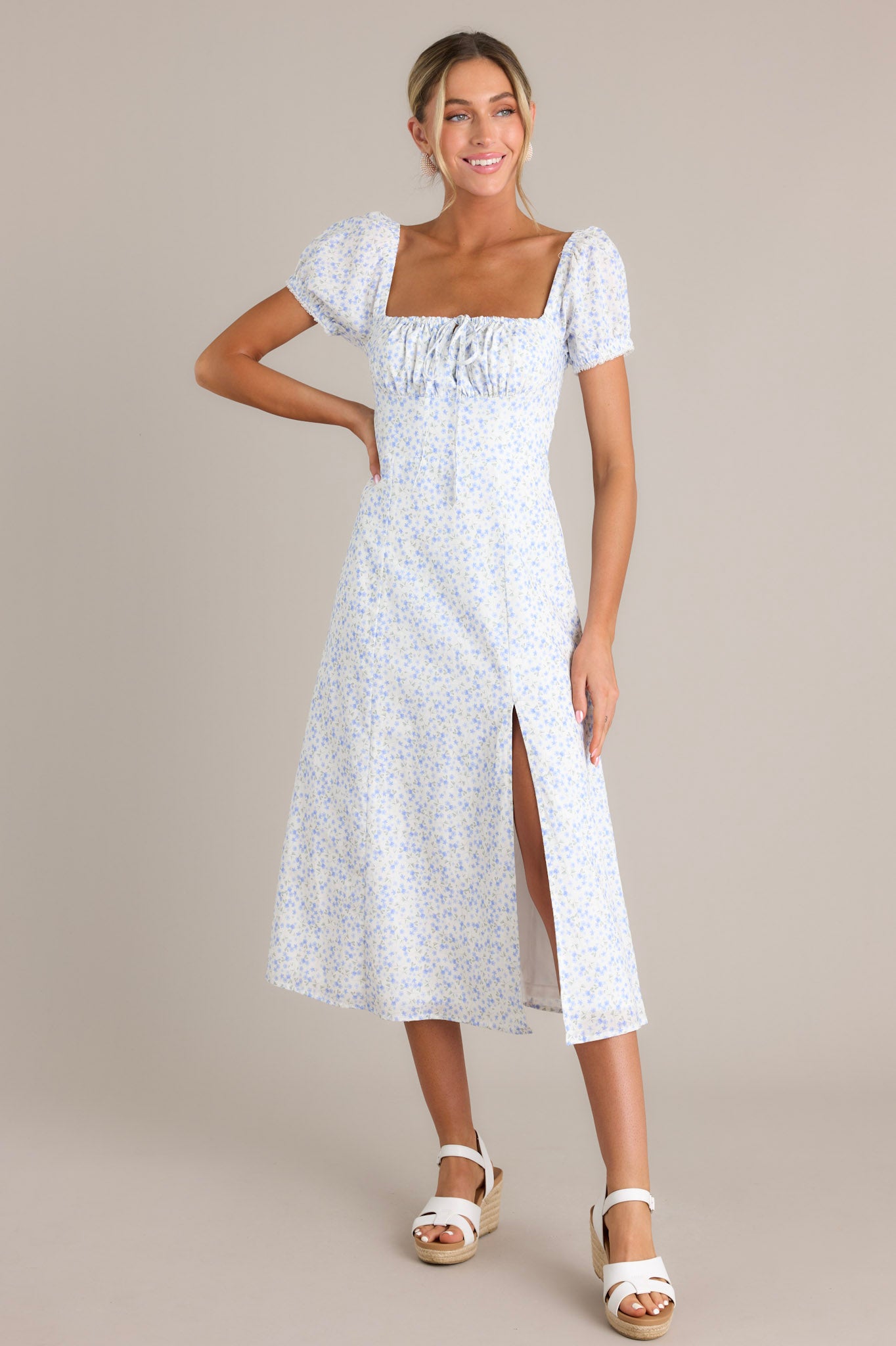 Light blue floral print dress with puff sleeves and a square neckline, featuring a ruched bust and a front slit.