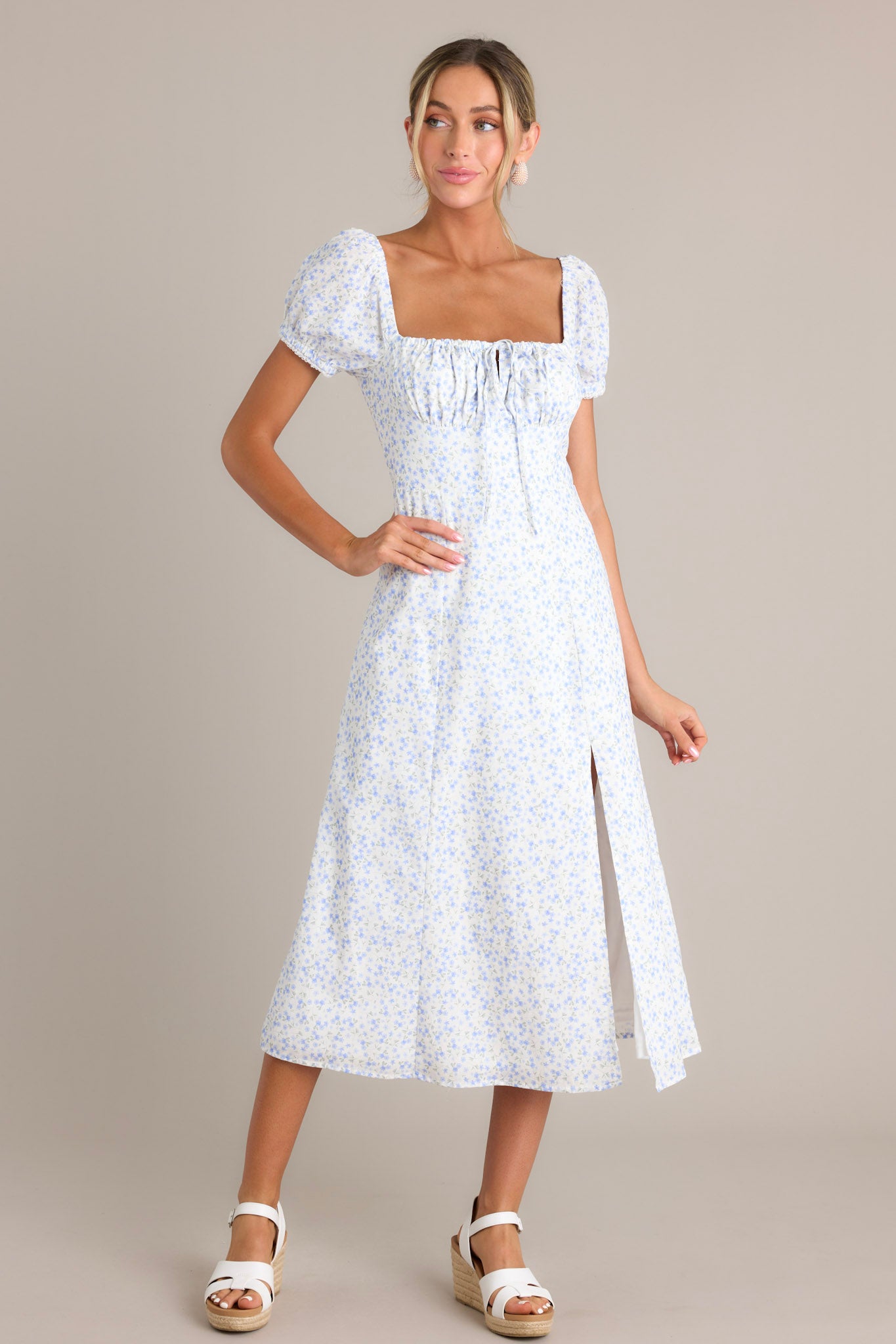 Light blue floral print dress with puff sleeves and a square neckline, featuring a ruched bust and fitted waist.