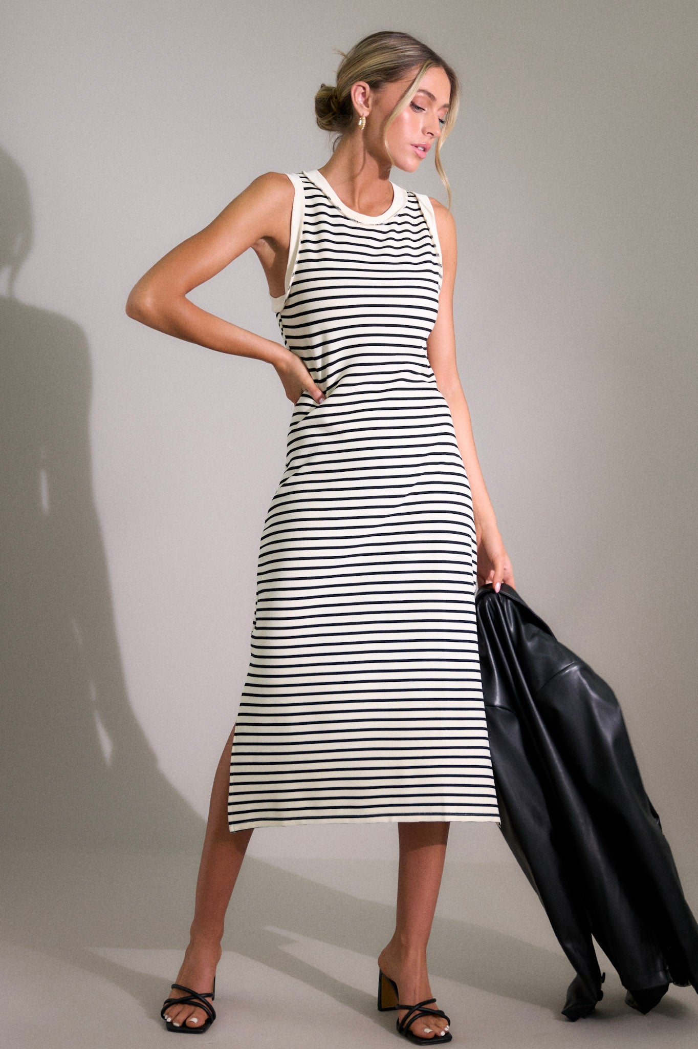 This stripe midi dress features a crew neckline, a classic horizontal stripe design, and a split hemline.