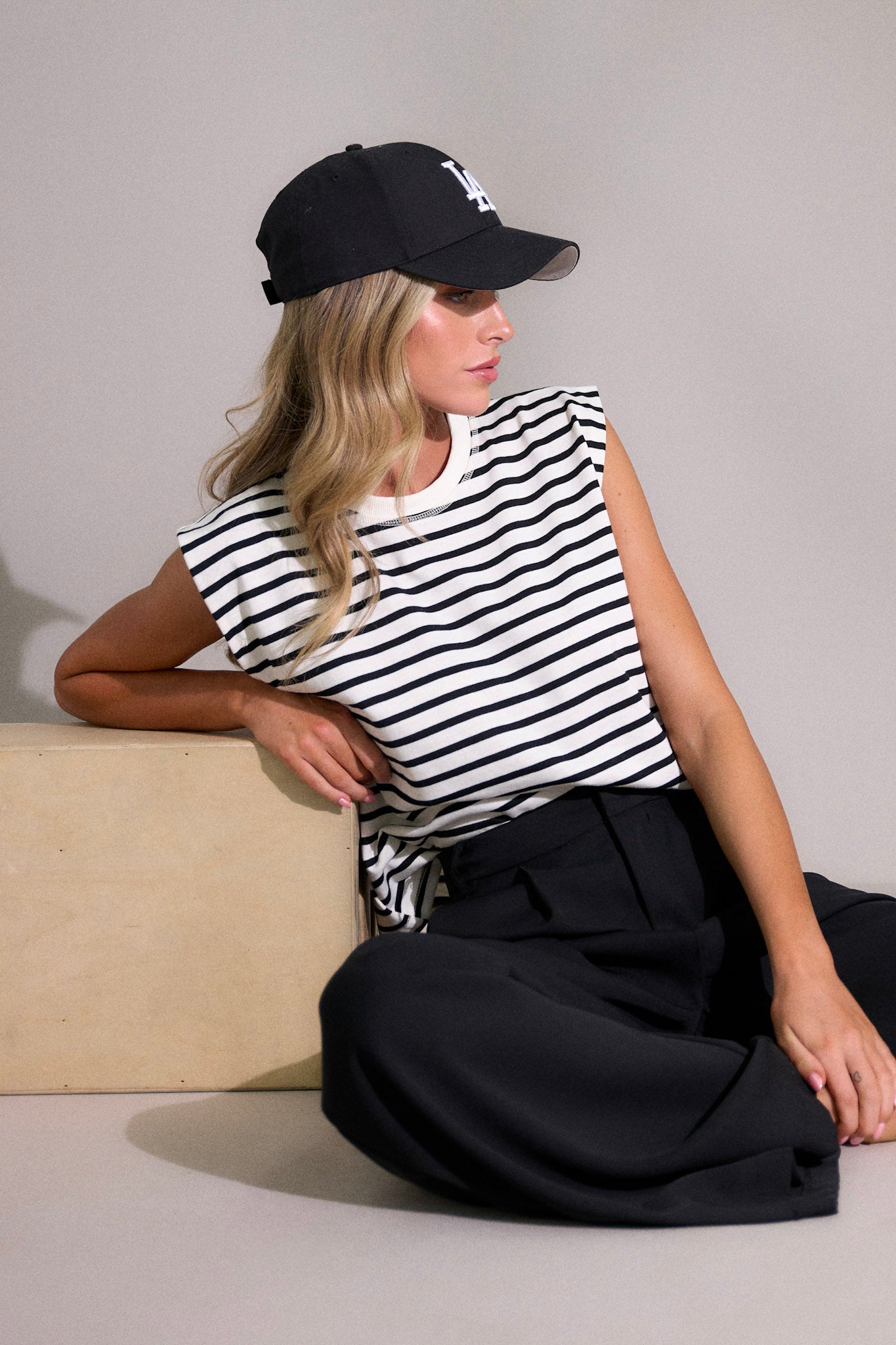 Close up view of this white stripe top features a crew neckline, short cap sleeves, and a classic stripe pattern.