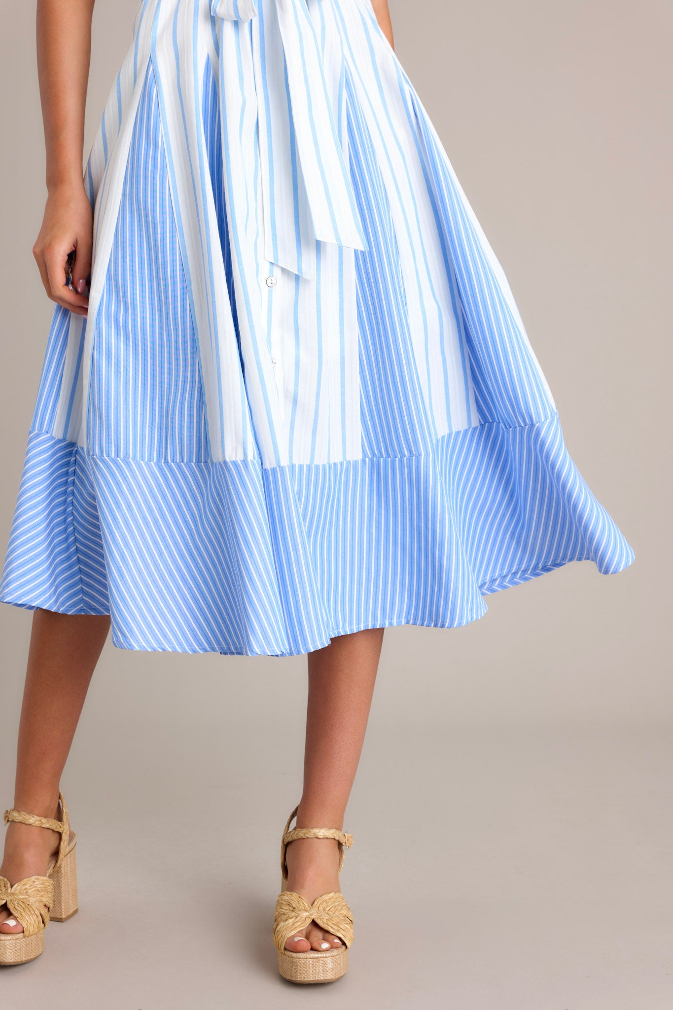 Close-up view of the bottom of this light blue midi dress.