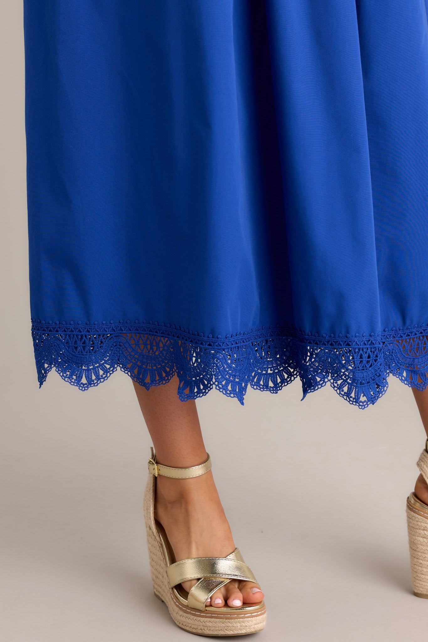 Close-up view of the lace detailing of this blue maxi dress showing the v-neckline, lace bust, and smocked waist & back.