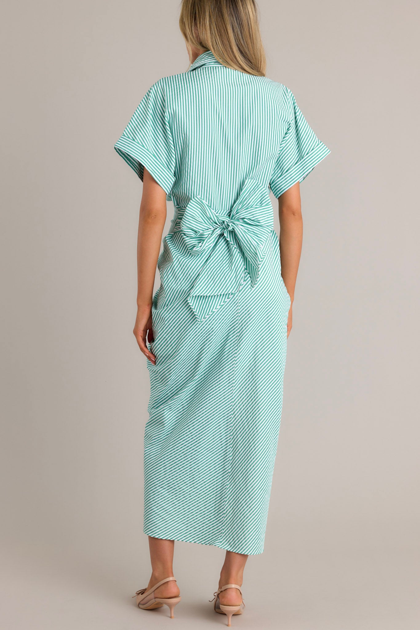 Back view of a green stripe midi dress highlighting the collared neckline, self-tie waist feature, and overall fit.