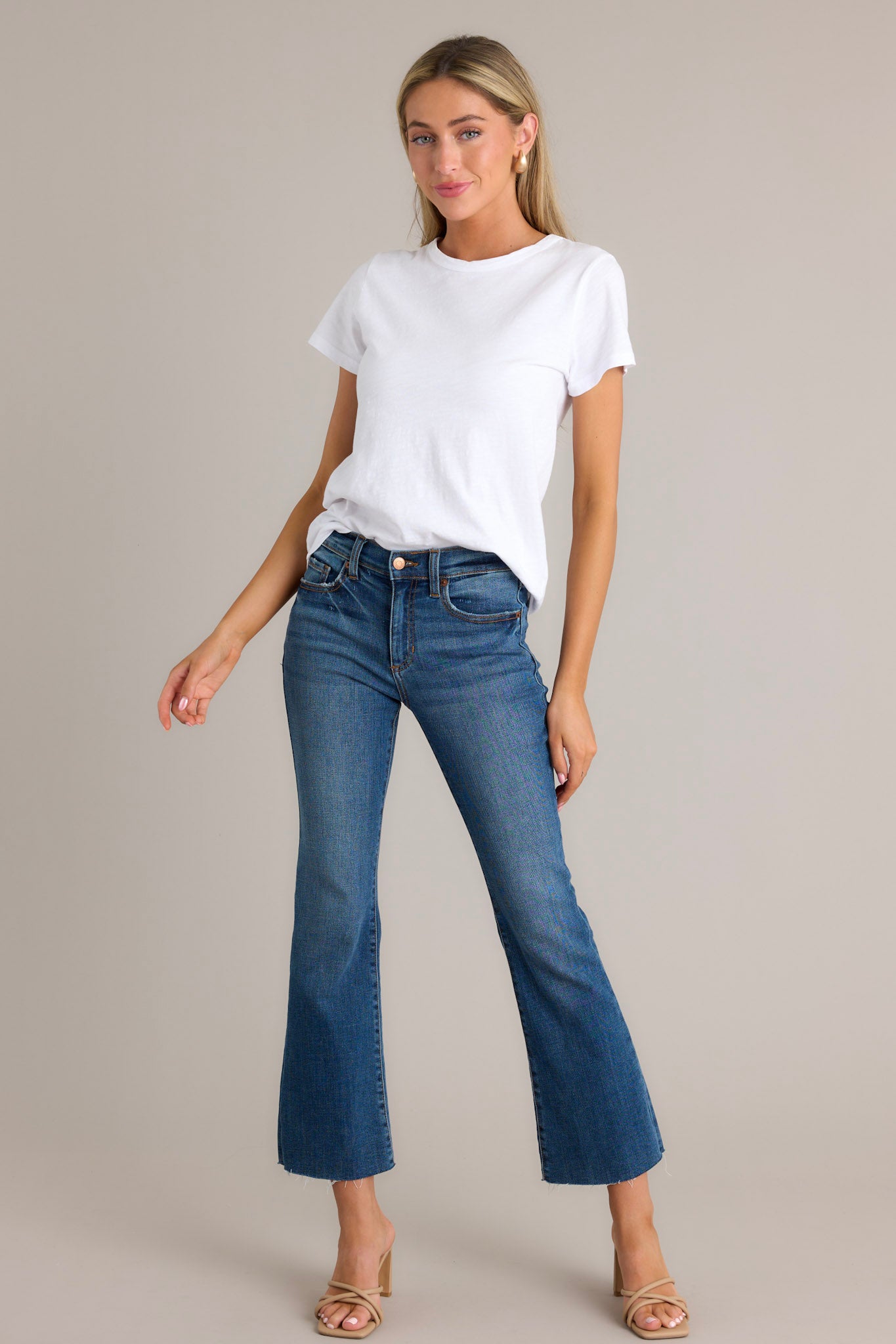 White tee with a crew neckline, exposed seams, and short sleeves.