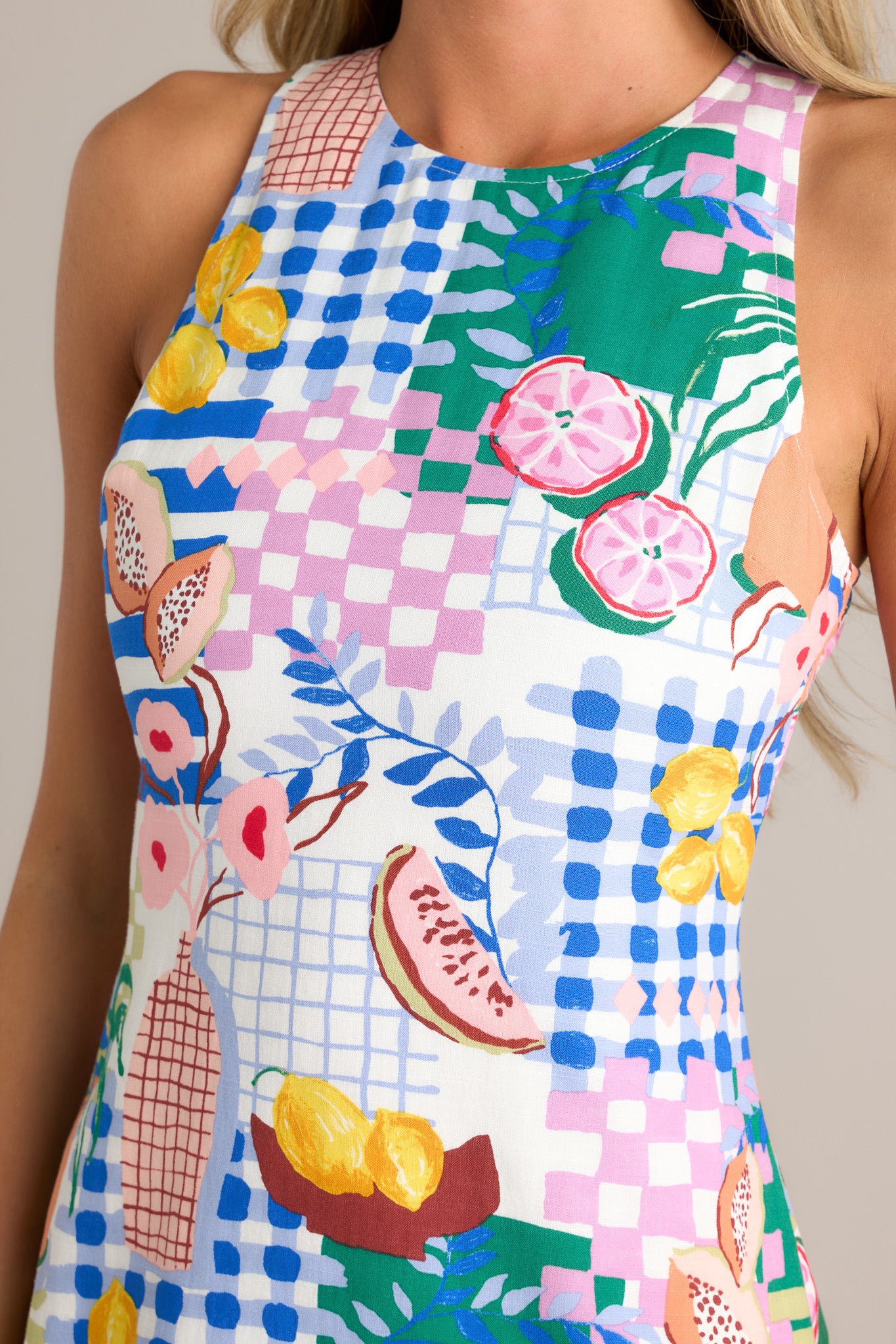 Close-up of the blue mini dress showing the round neckline, keyhole cutout, and fun and unique print.