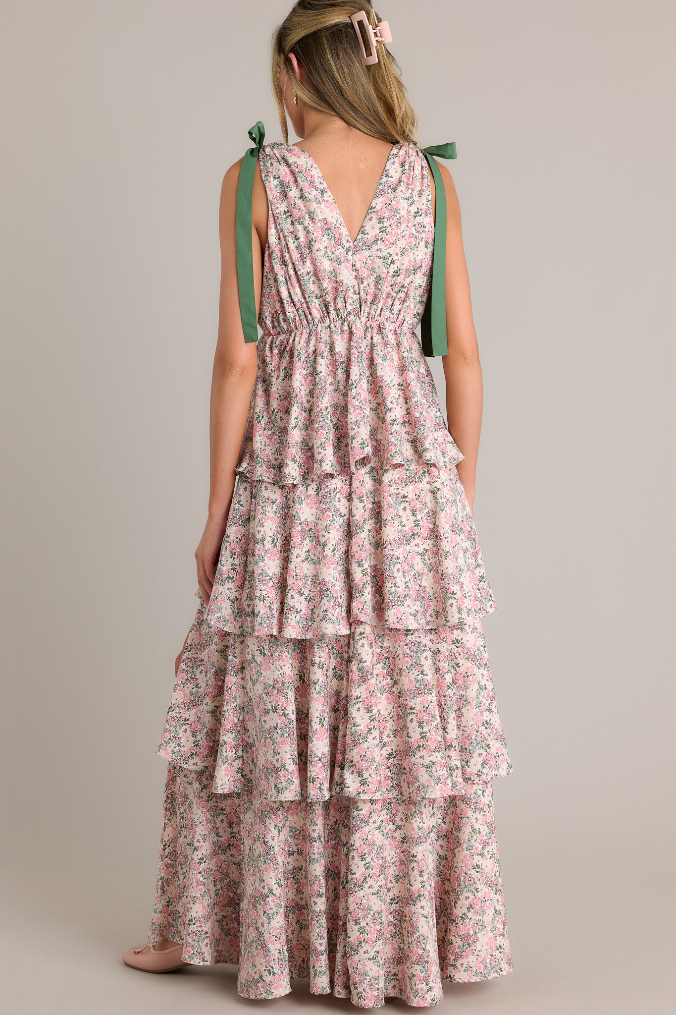 Back view of a pink floral maxi dress highlighting the self-tie shoulder features, elastic waistline, and overall fit.