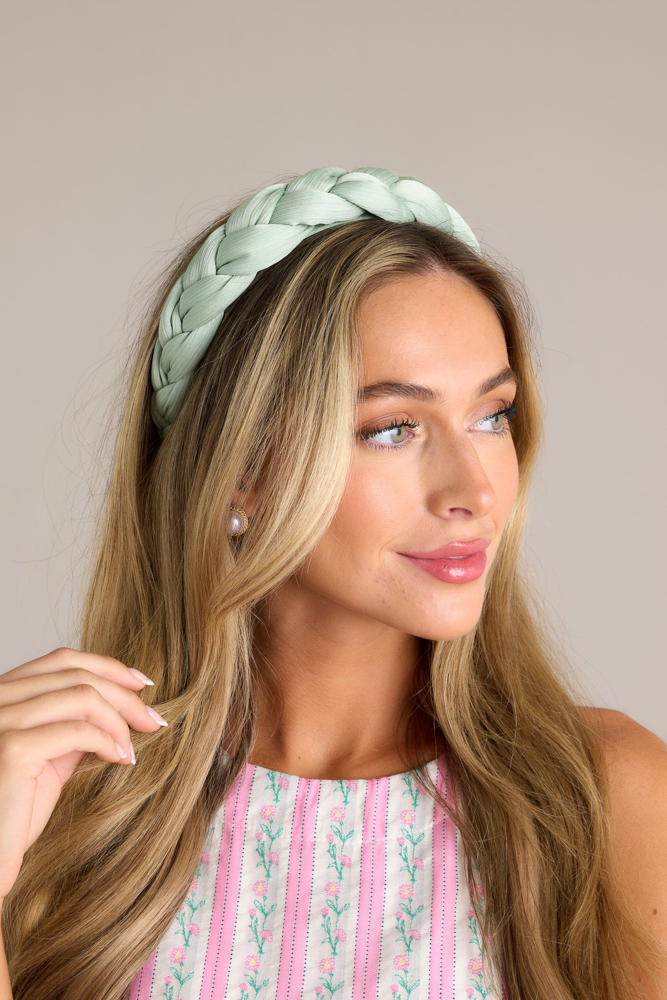 This headband features a thick, soft material, and a braided texture.