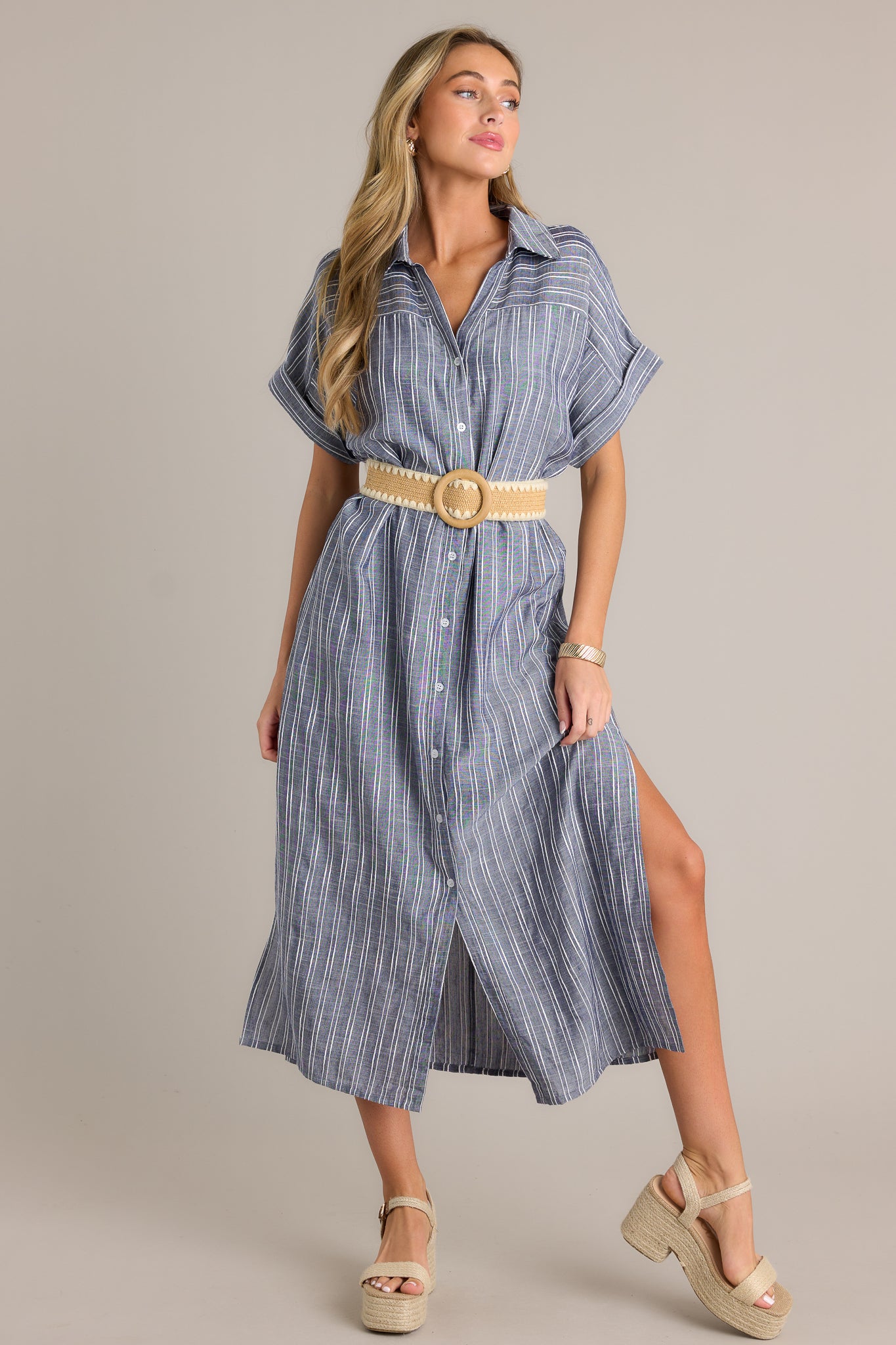 Front view of a blue dress featuring a functional button front, an optional self-tie belt, a collared neckline, and cuffed short sleeves.