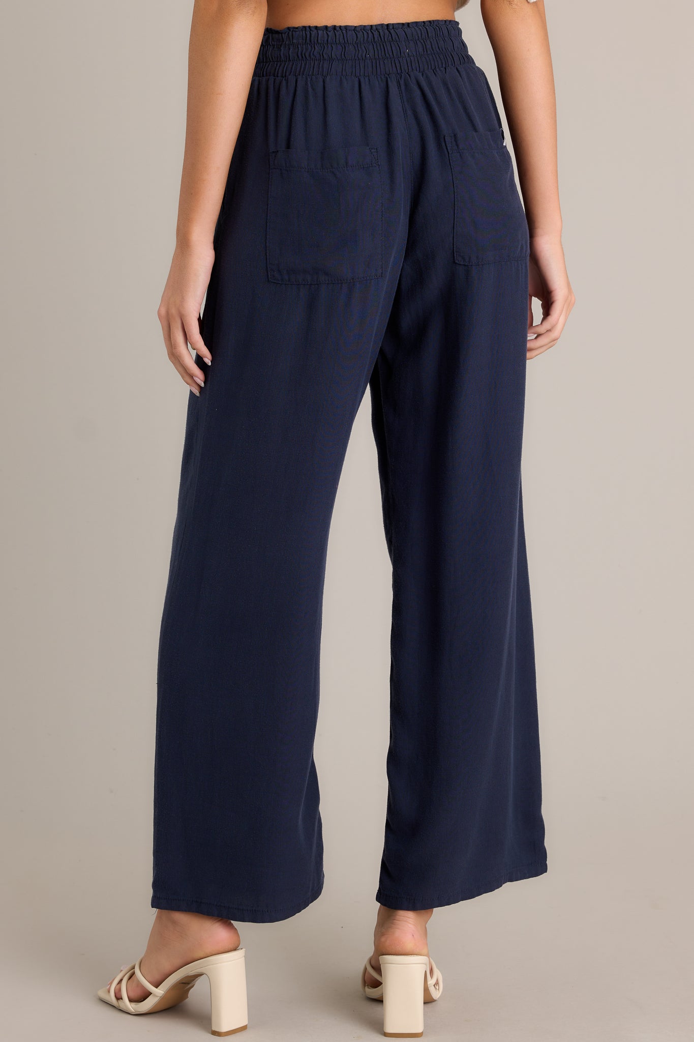 Back view of these Navy wide-leg pants with an elastic waistband and drawstring