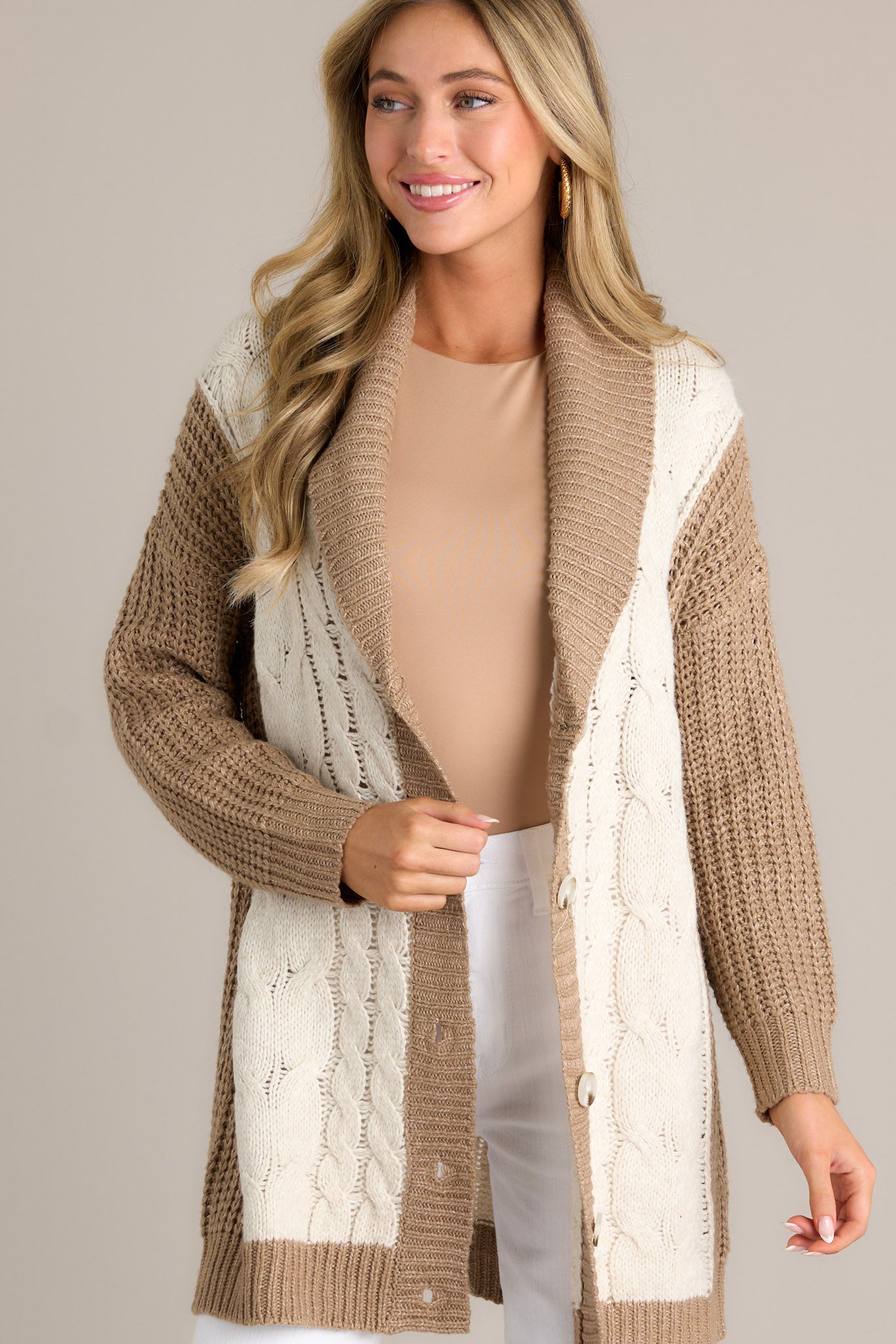 Angled Front view of  this cardigan that features long sleeves with ribbed cuffs.