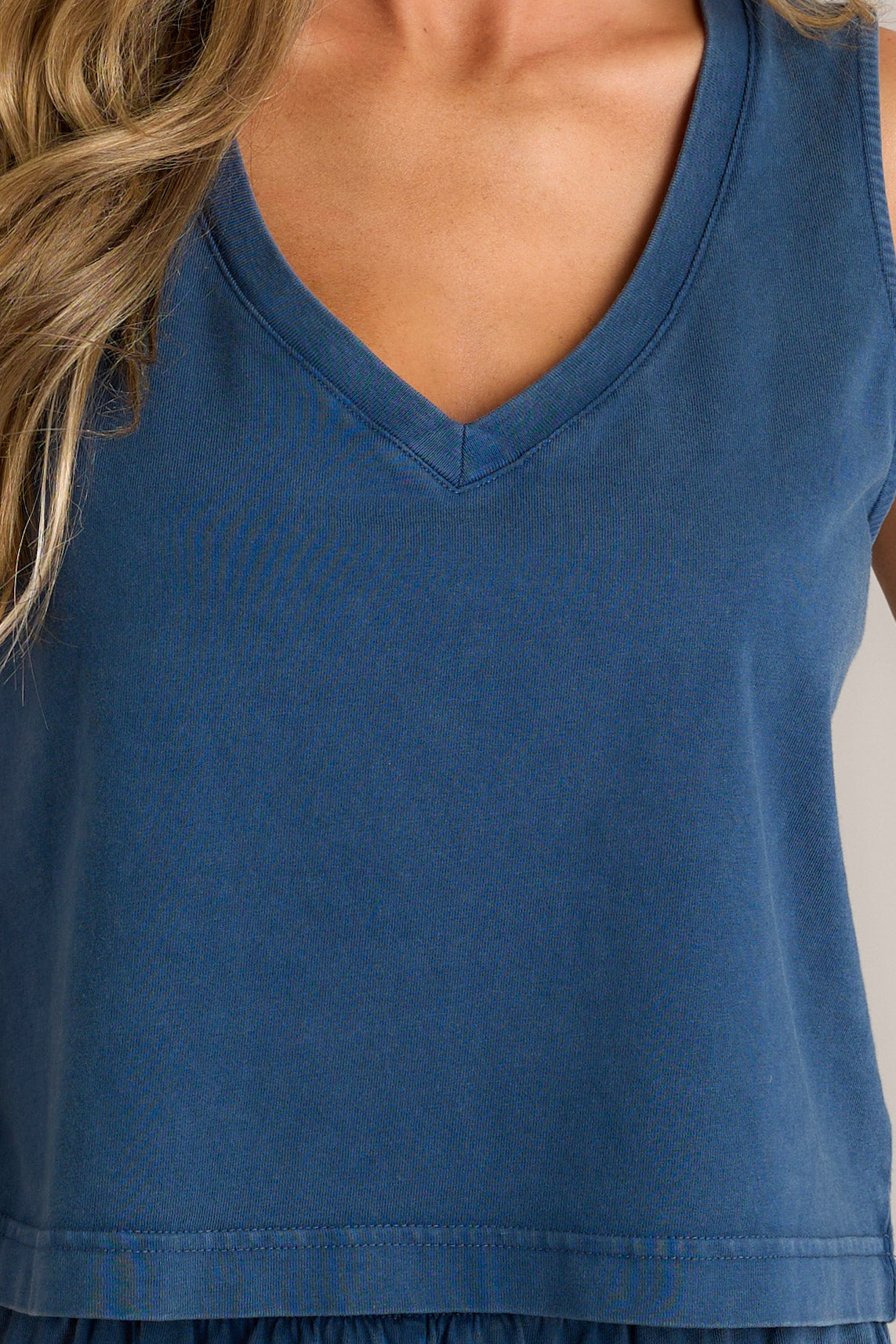 Close-up of the blue tank showing the v-neckline and sleeveless design.