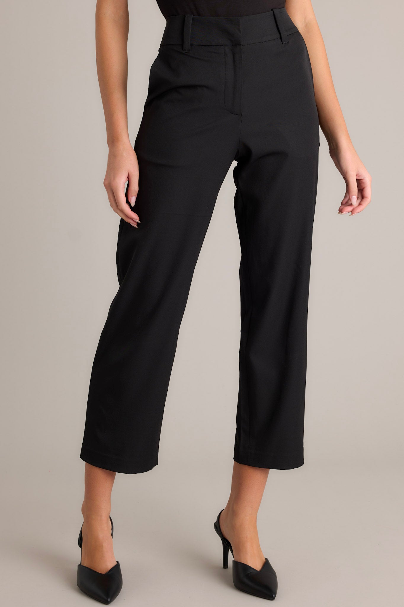 Black straight leg pants highlighting the functional belt loops, zipper hook closure, and functional hip pockets.