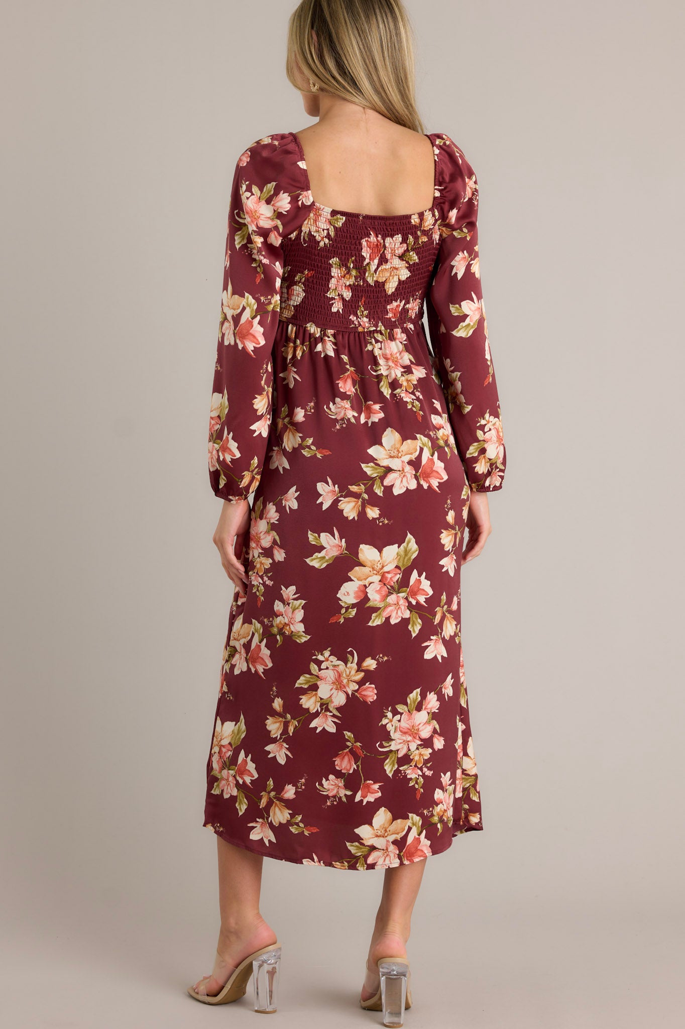 Back view of the burgundy floral dress featuring a square neckline and smocked back.