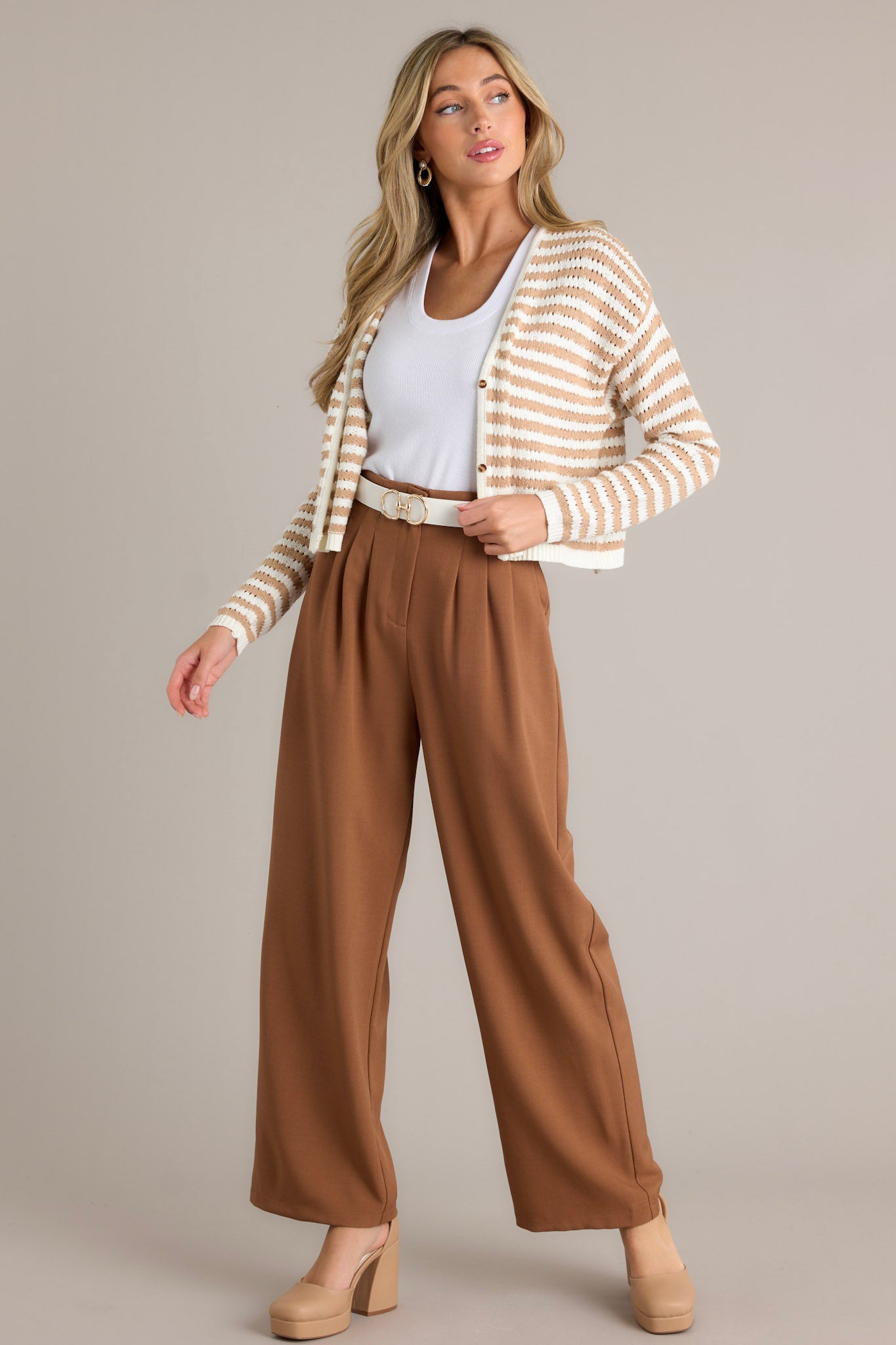 Full length view of a tan stripe cardigan with a v-neckline, functional buttons, an open knit design, a cropped hemline, and ribbed cuffed sleeves