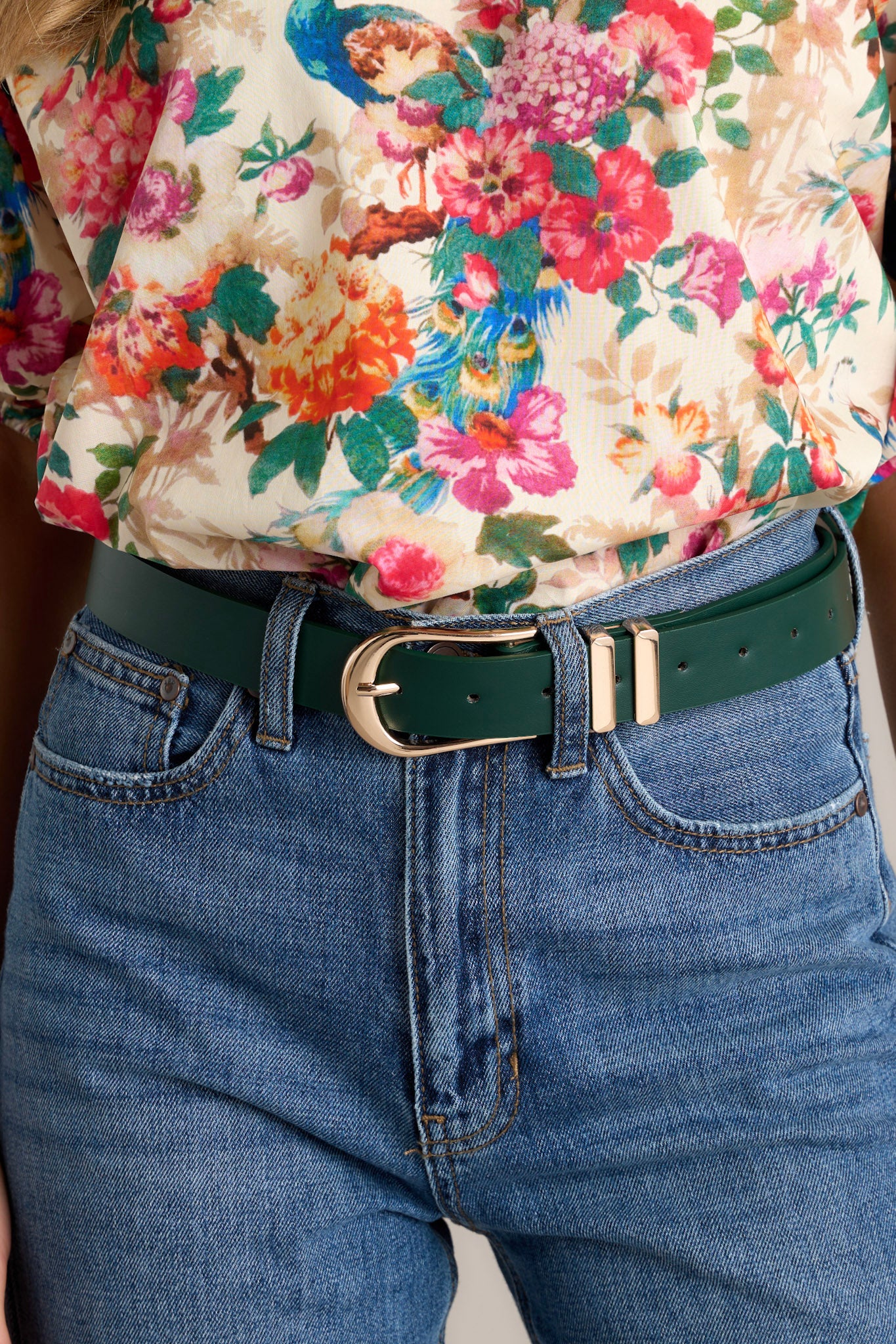 This hunter green belt features gold hardware buckle, a tan inside and two gold belt loops.