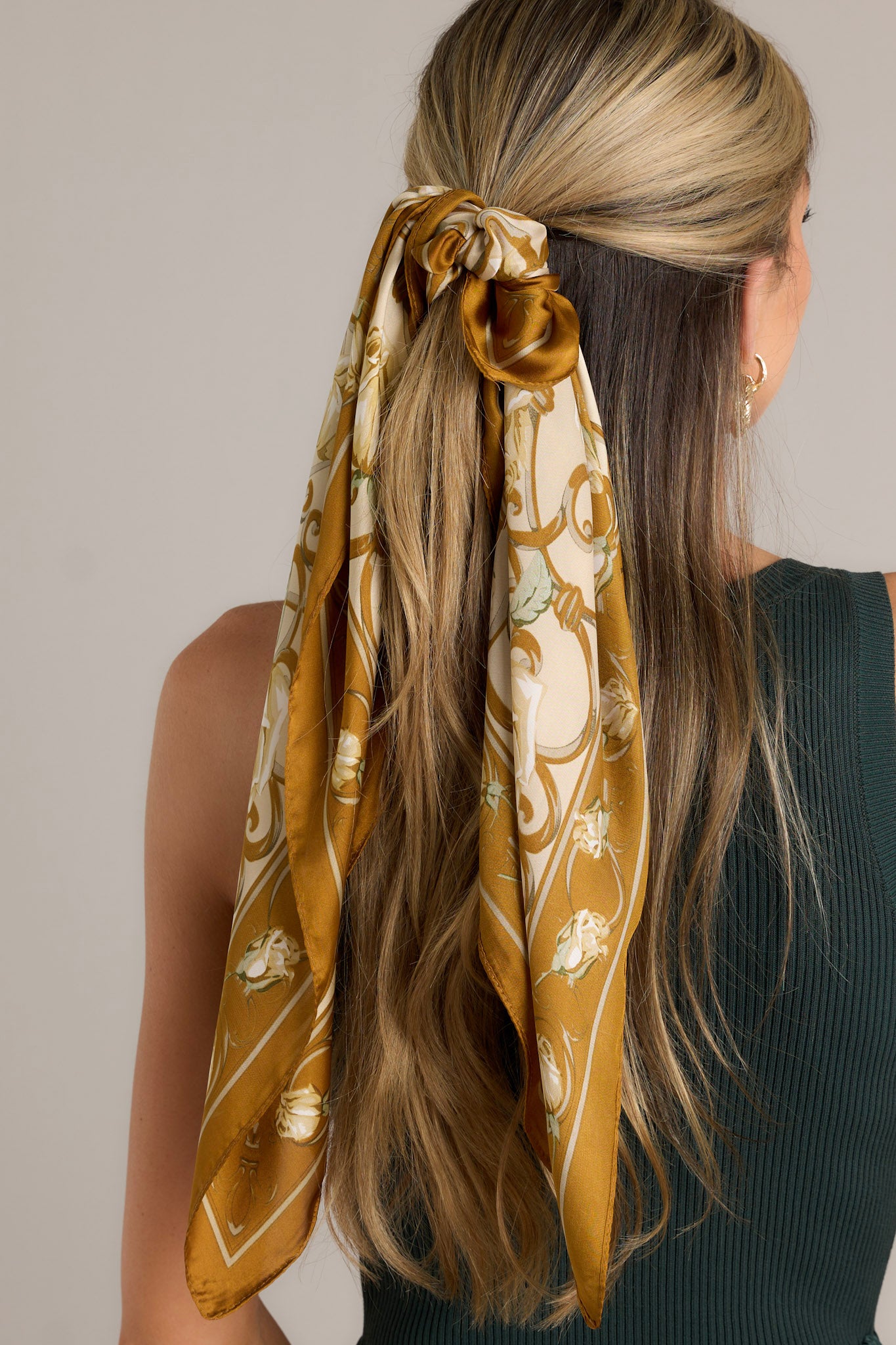 This khaki multi print scarf features a satin material, and a multicolored floral print.