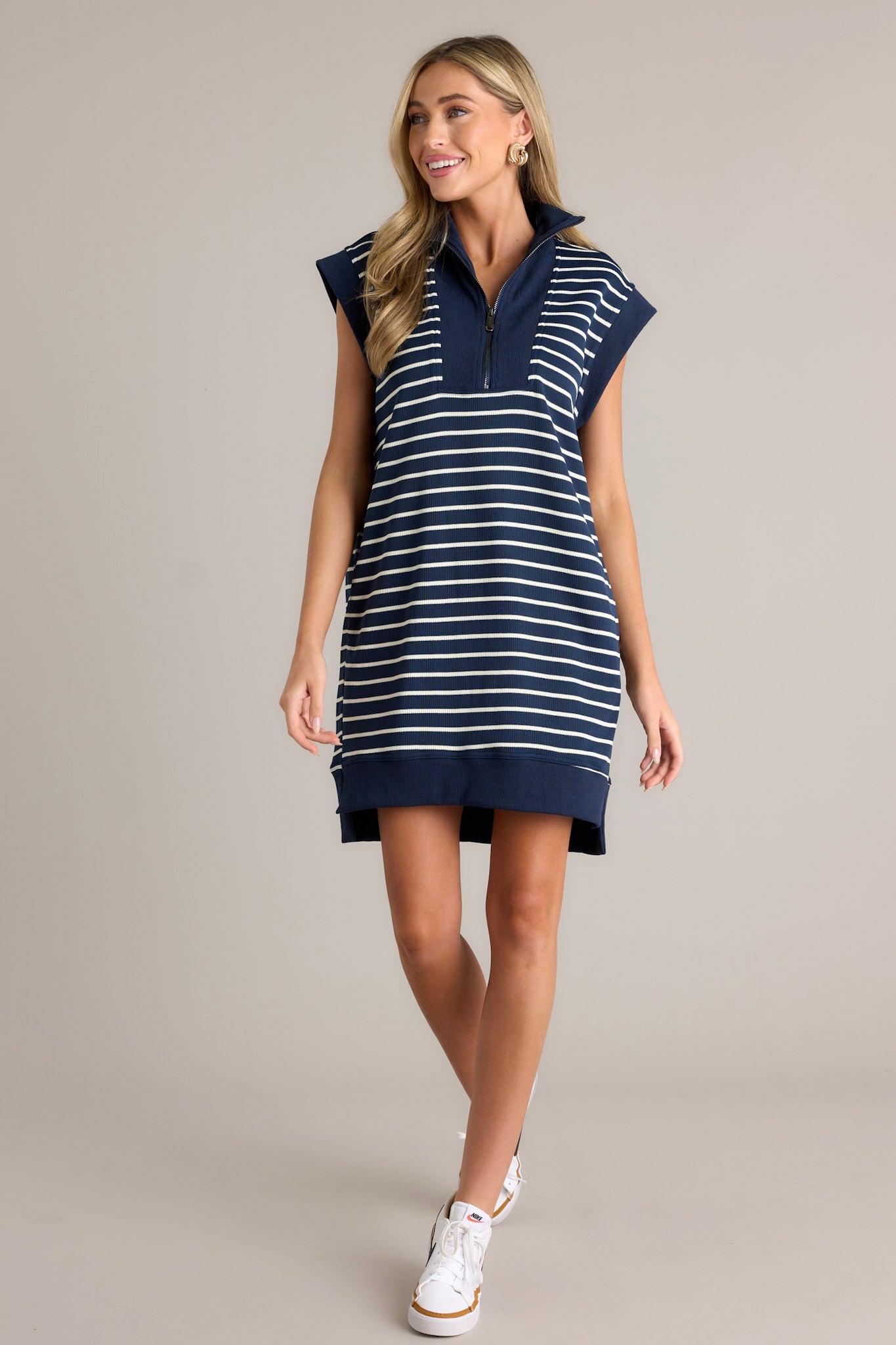 Navy and white striped dress with a collared neckline, quarter-zip front, cap sleeves, and functional pockets.