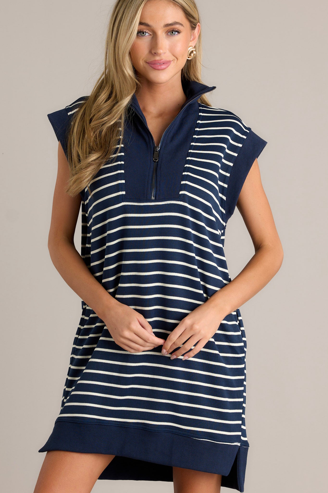  Chic navy and white striped dress with a collared neckline, quarter-zip front, cap sleeves, and functional side pockets.